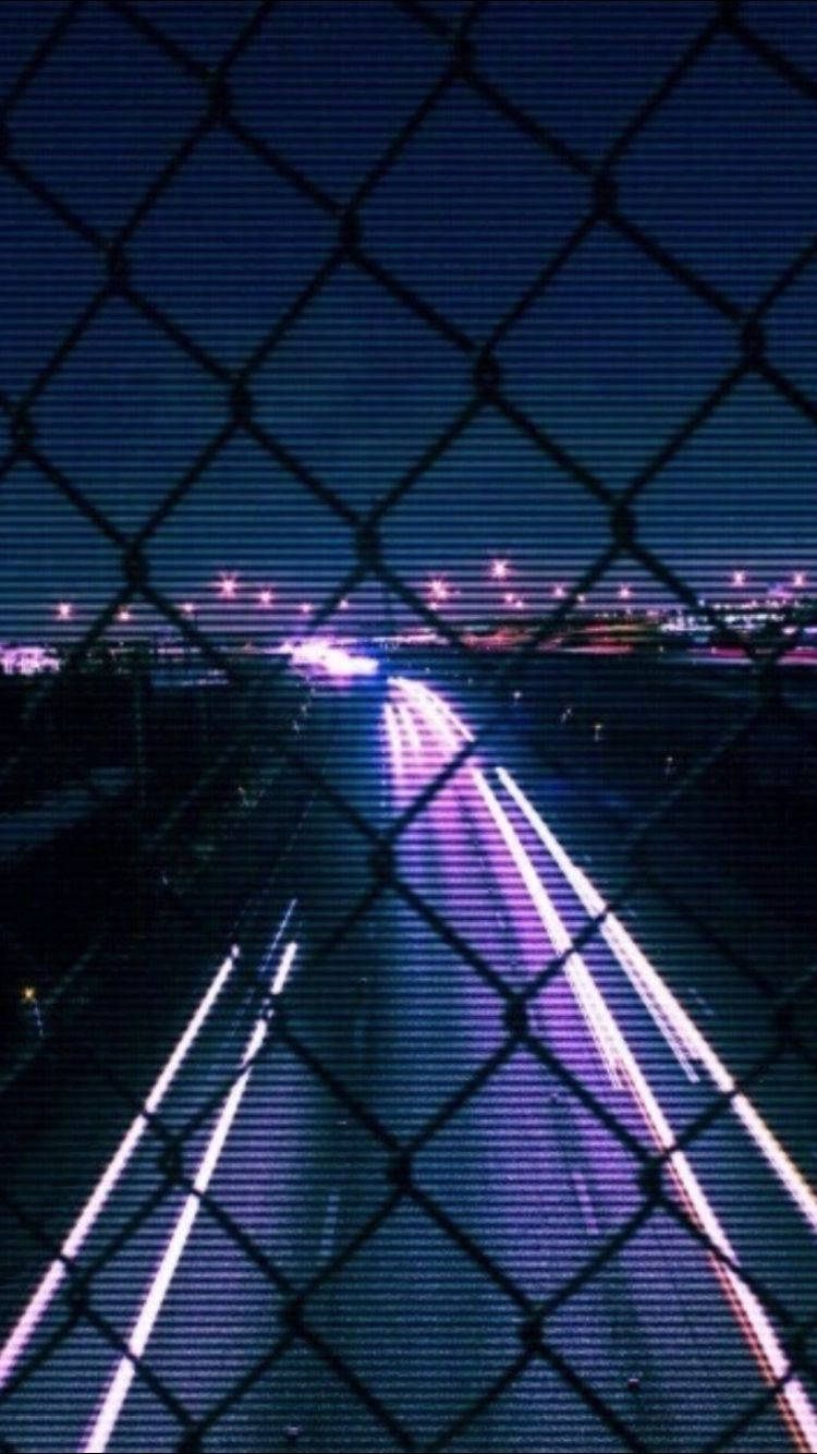 neon-lit highway, night, chain-link fence, HD Phone Wallpaper