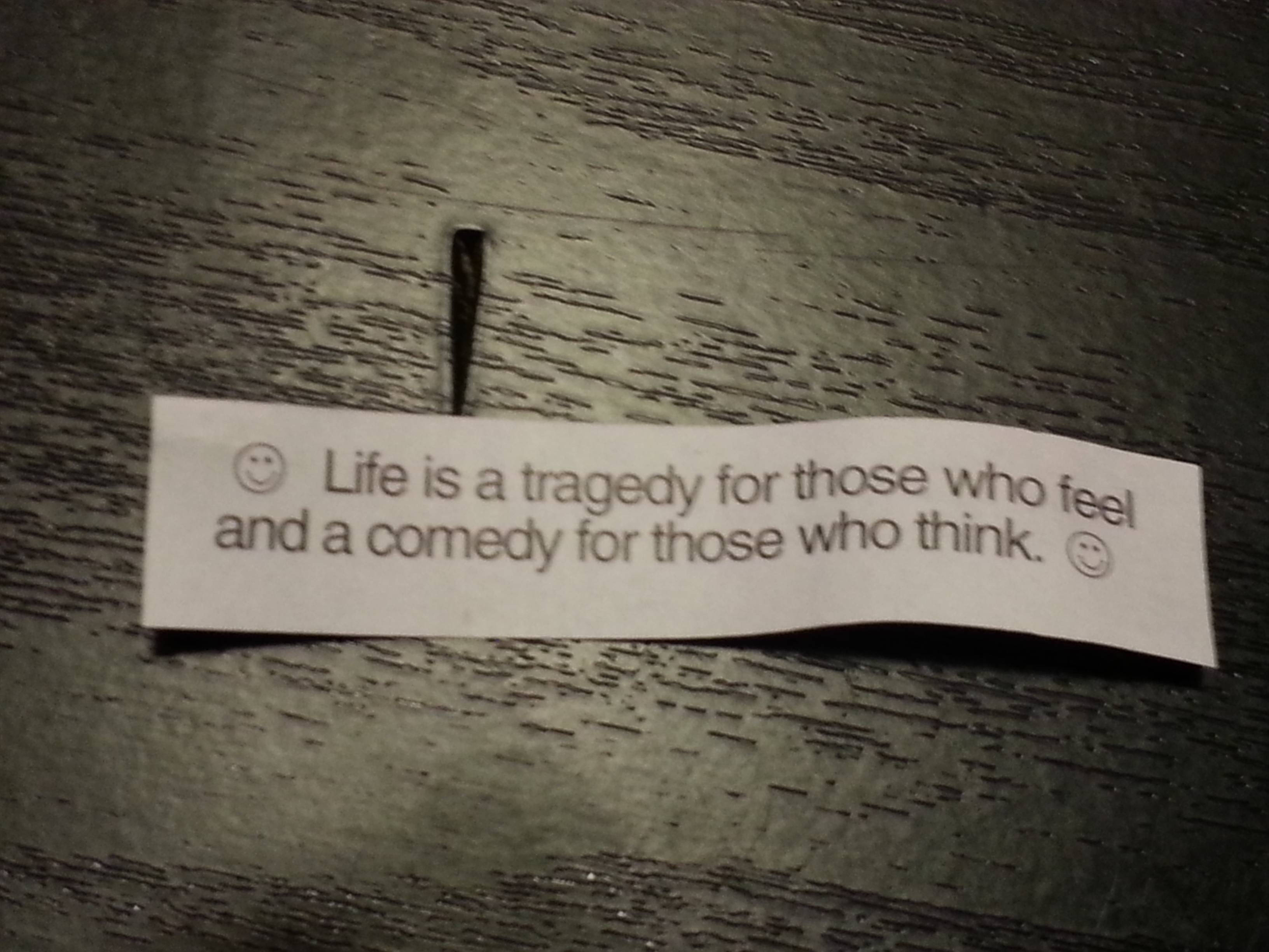 paper note, quote about life as tragedy or comedy, dark wood surface, 2K Desktop Wallpaper