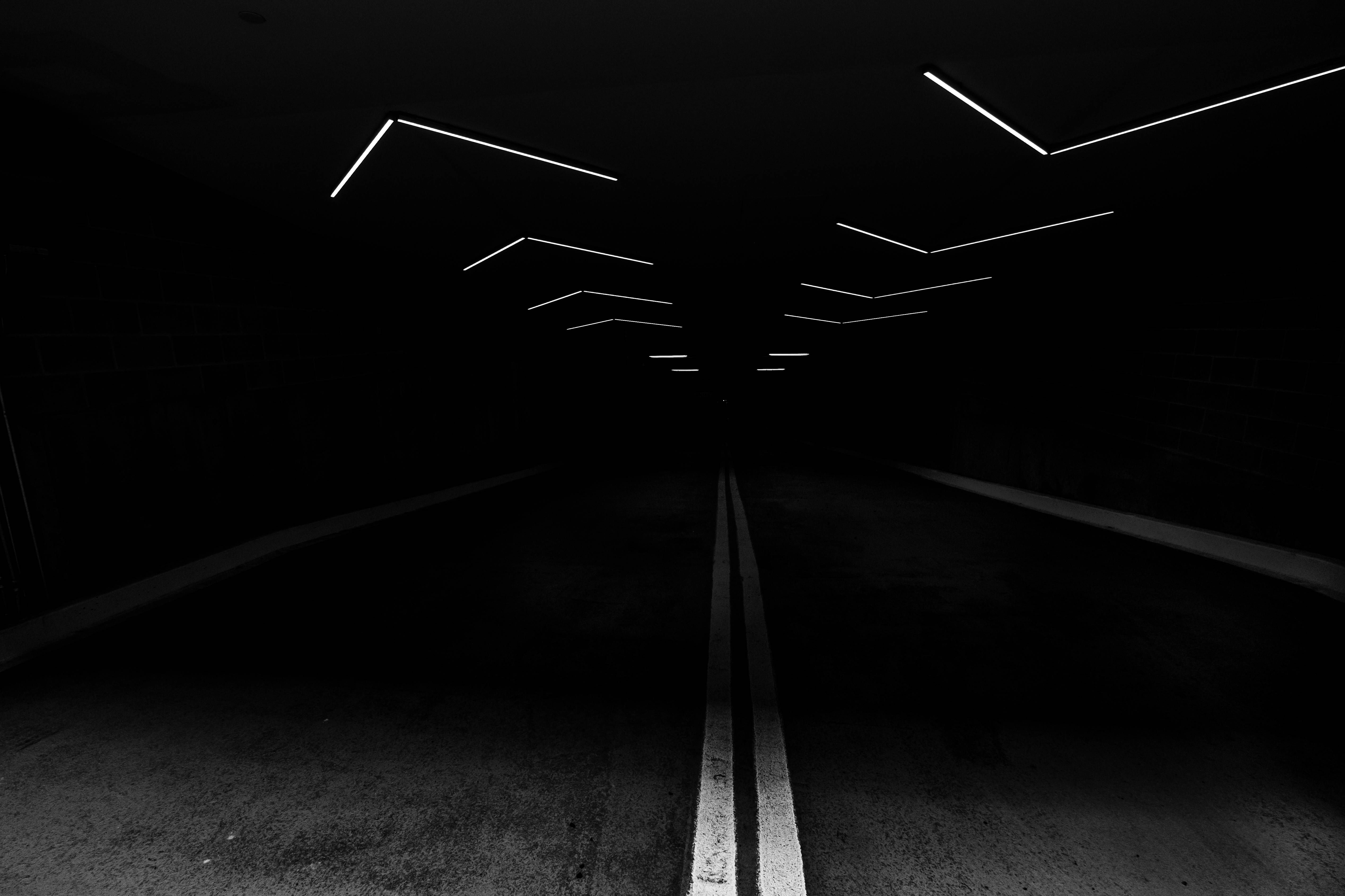 Dark Lit Road, glowing white geometric lights, centered road line, 5K Desktop Wallpaper