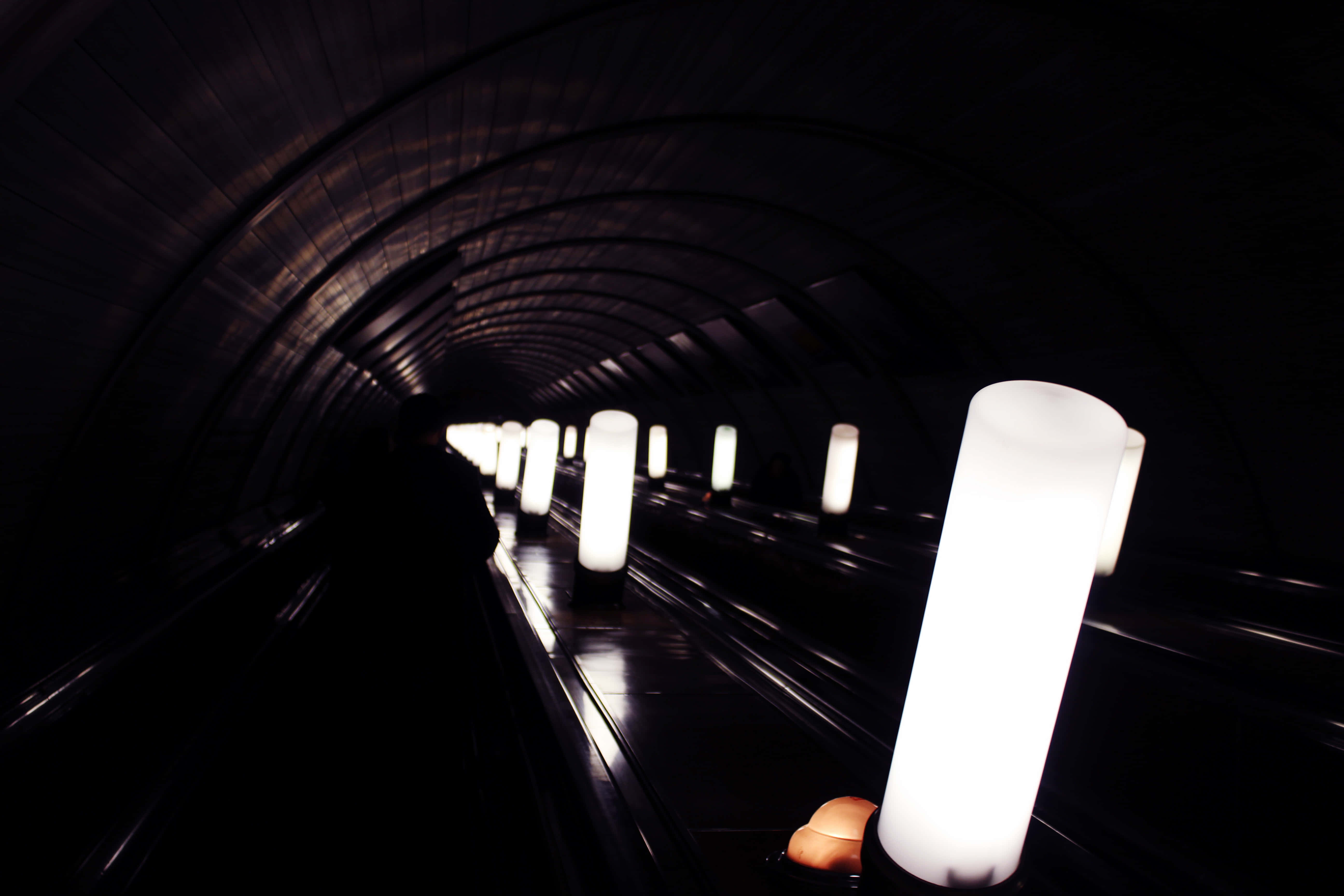 Dark Underground, curved subway tunnel, glowing cylindrical lights, 5K Desktop Wallpaper