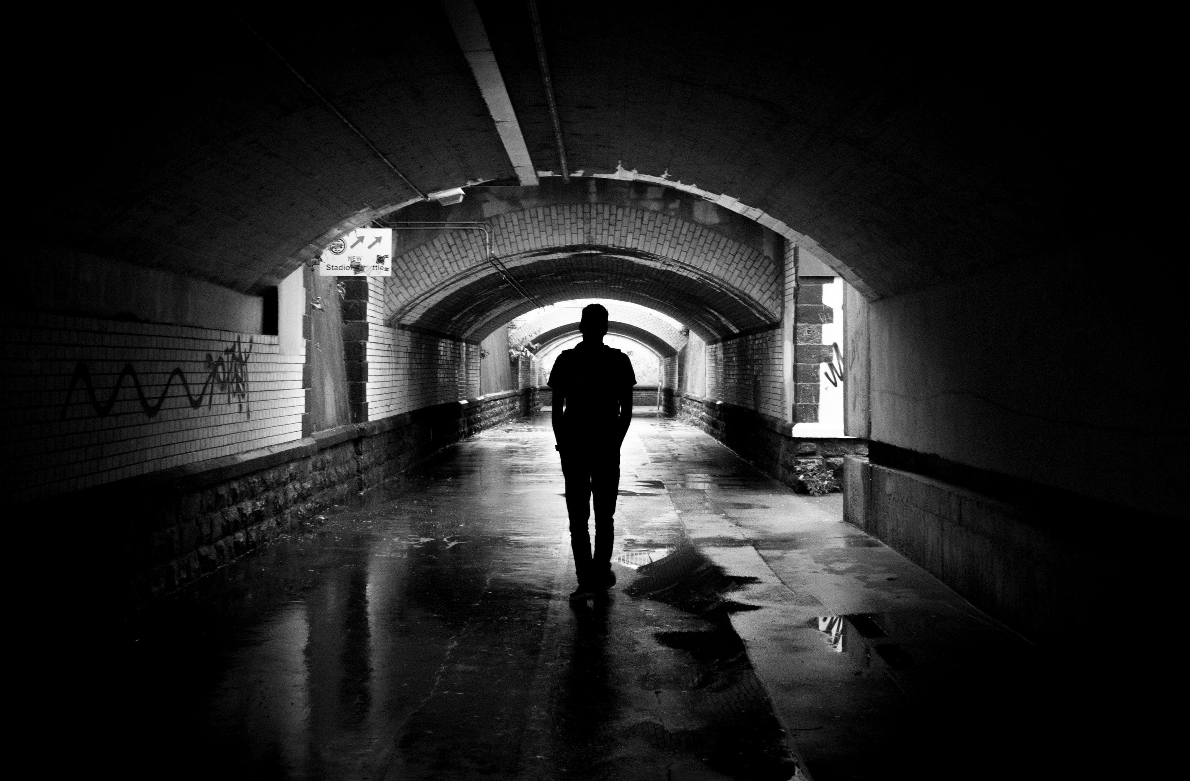 Dark Underground, wet, graffiti-marked brick tunnel, 4K Desktop Wallpaper