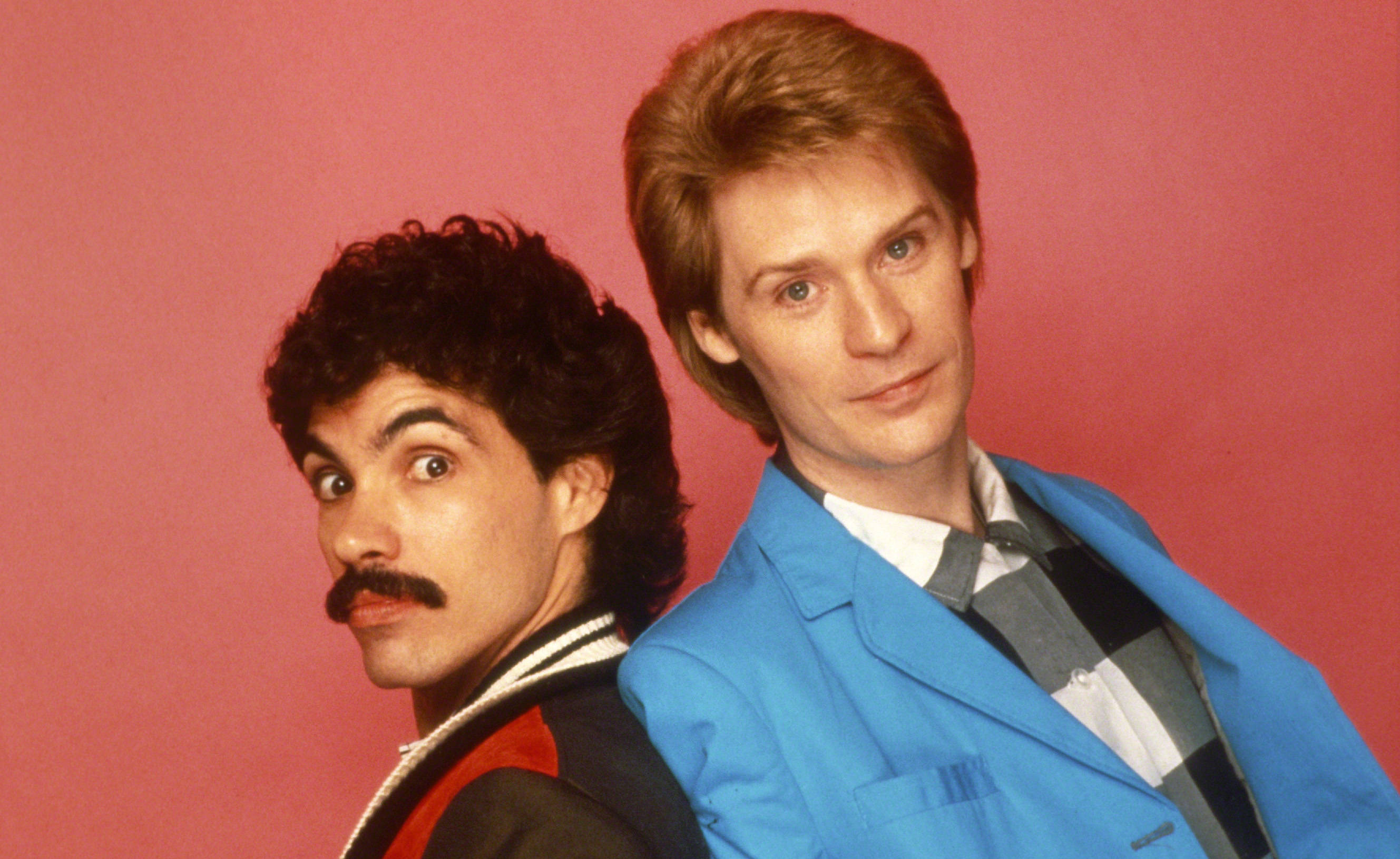 Daryl Hall John Oates, 1980s attire, solid pink studio backdrop, 2K Desktop Wallpaper