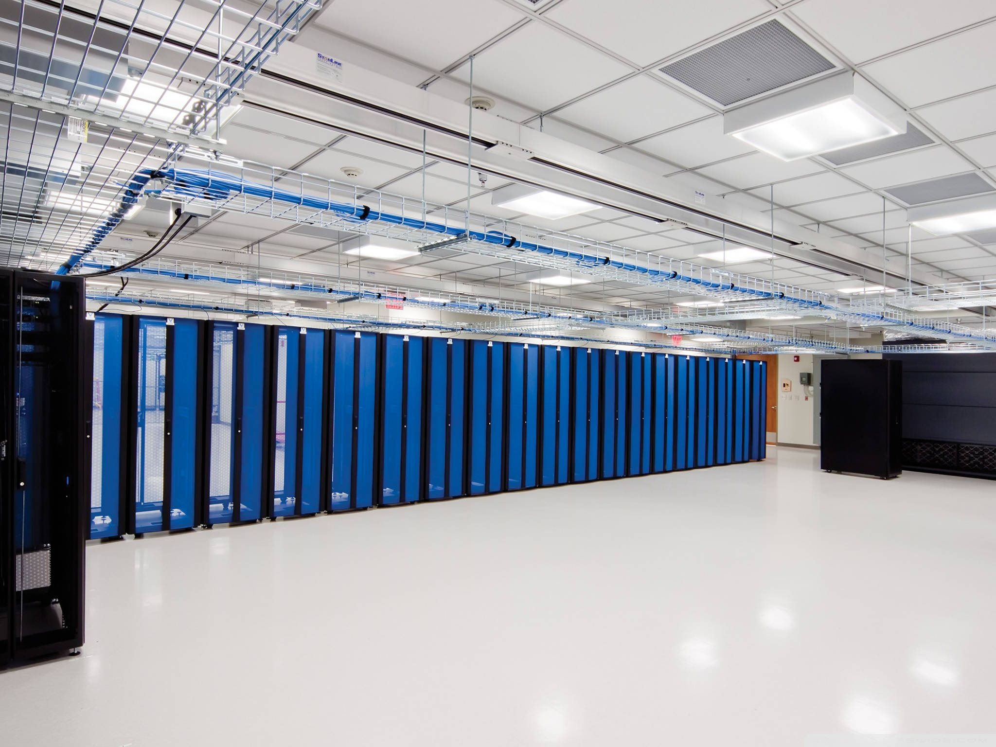 blue server racks, bright white data center floor, exposed ceiling conduits, Full HD Desktop Wallpaper