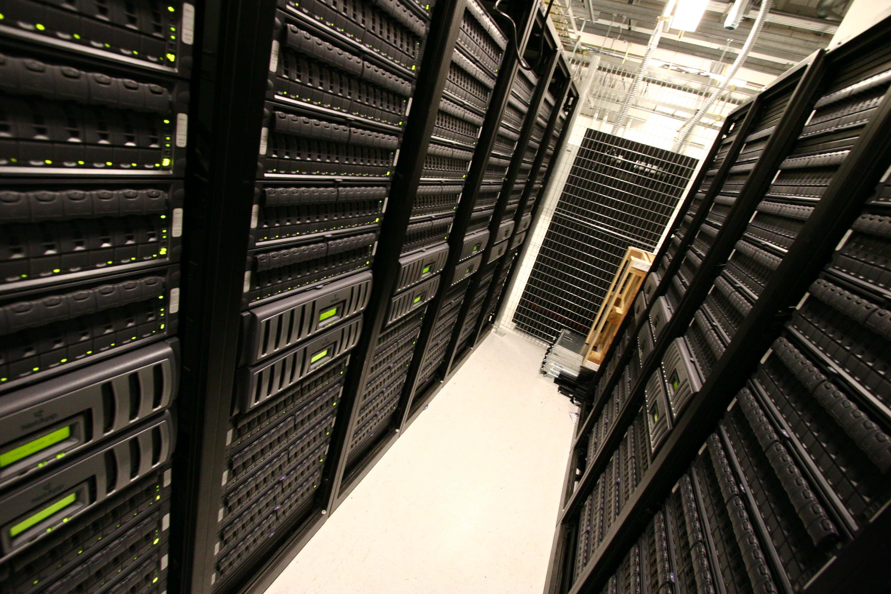 data management, black server racks, glowing green lights, 2K Desktop Wallpaper
