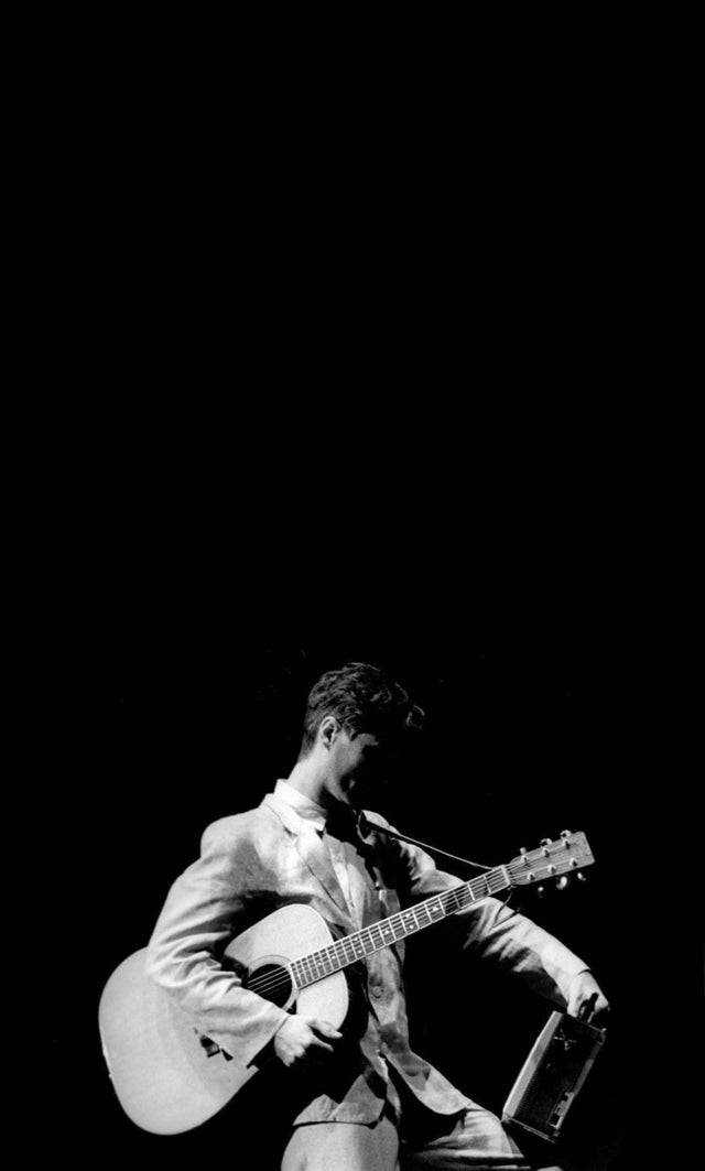 David Byrne, black background, acoustic guitar, SD Phone Wallpaper