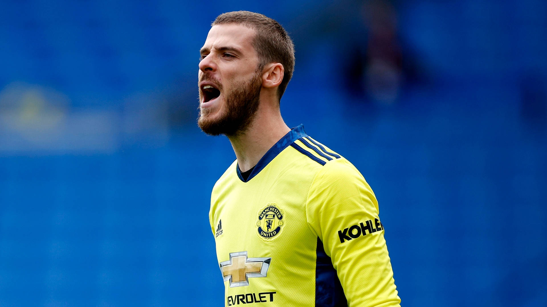 David de gea, bright yellow Manchester United kit, blue stadium backdrop, Full HD Desktop Wallpaper