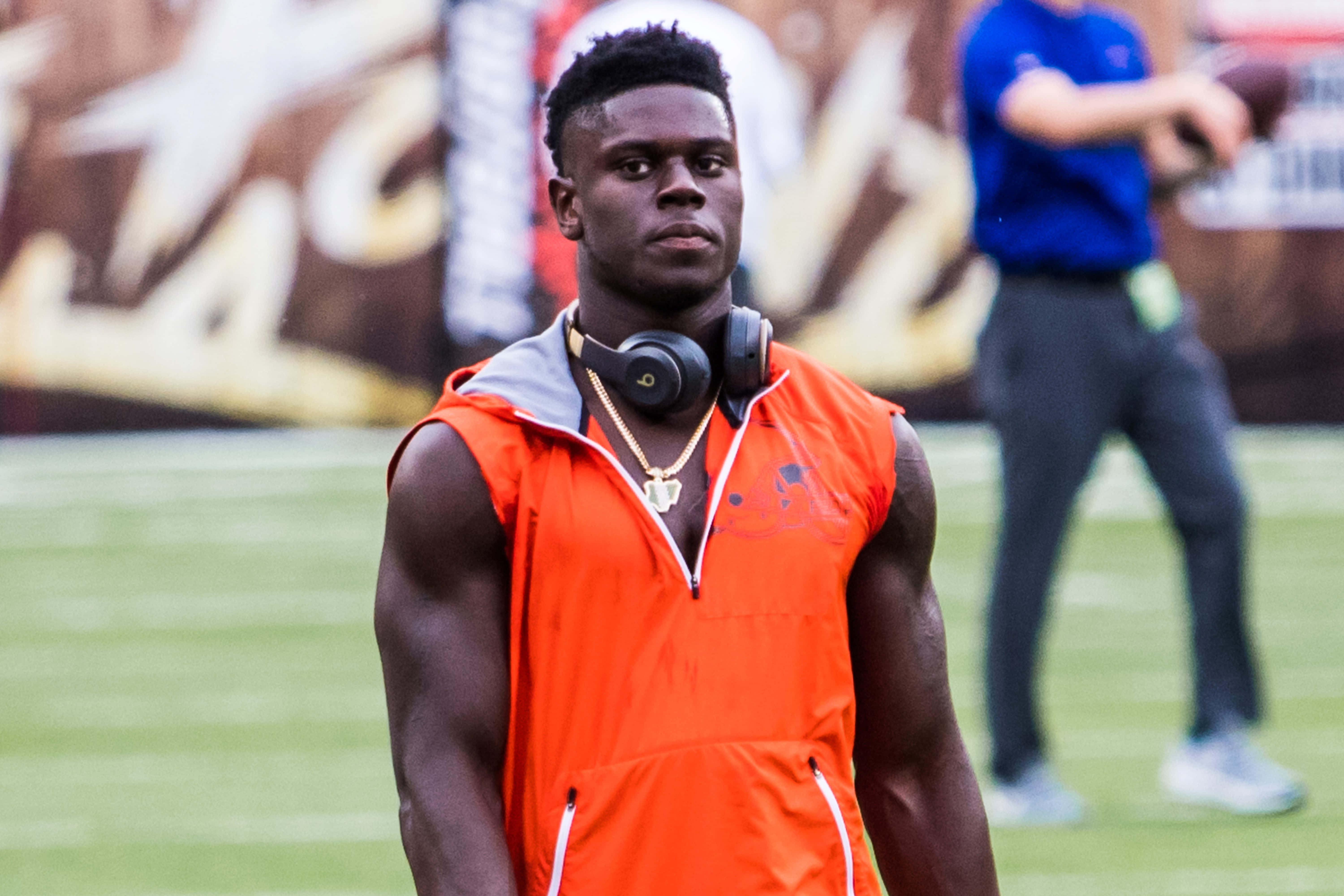 David Njoku, orange sleeveless jacket, green field, 5K Desktop Wallpaper