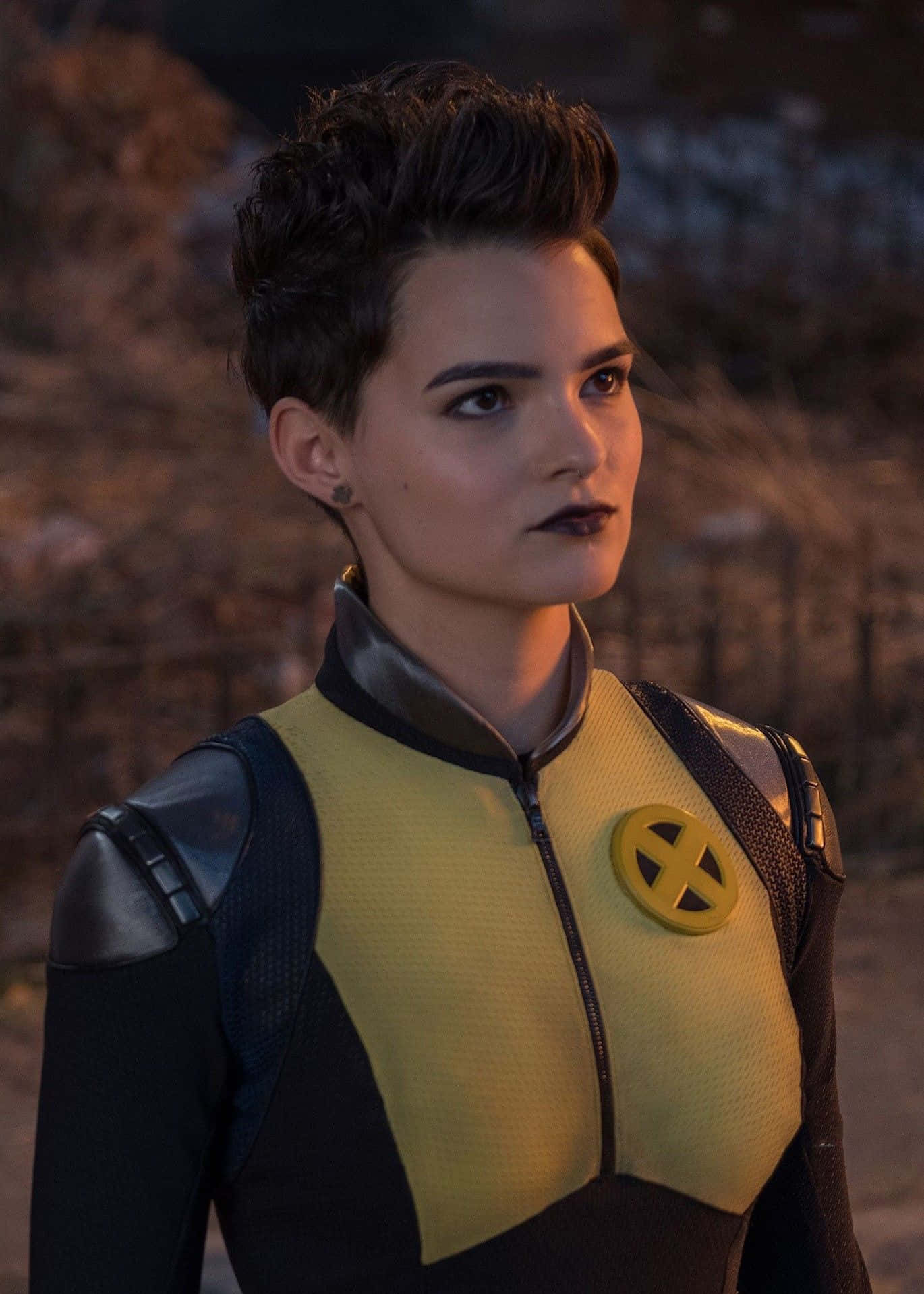 Negasonic Teenage Warhead, yellow and black X-Men suit, dimly lit outdoor setting, HD Phone Wallpaper