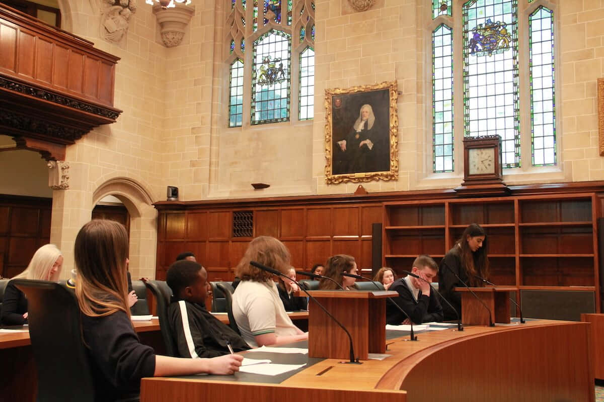 wooden desks, grand stone-walled courtroom, stained glass windows, SD Desktop Wallpaper