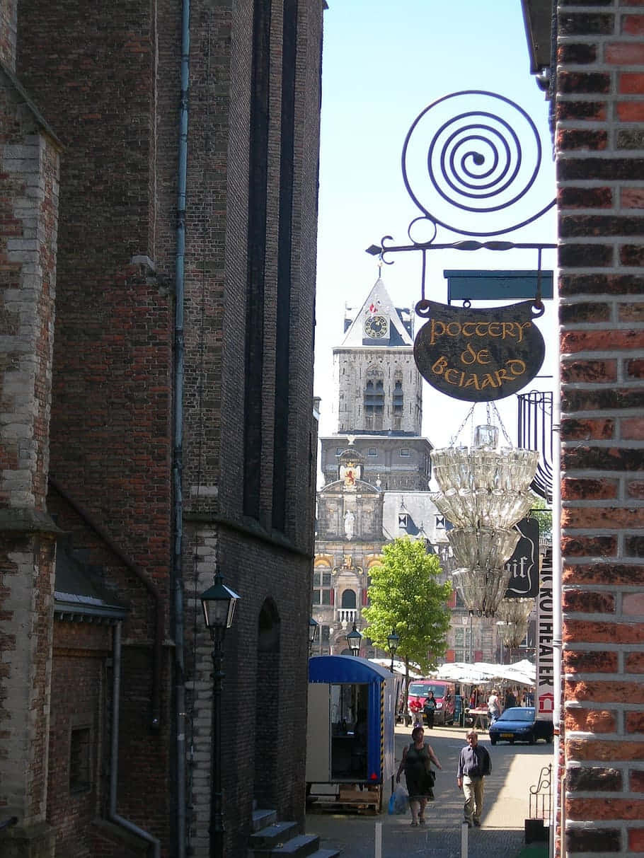 Delft, church tower, pottery shop sign, SD Phone Wallpaper