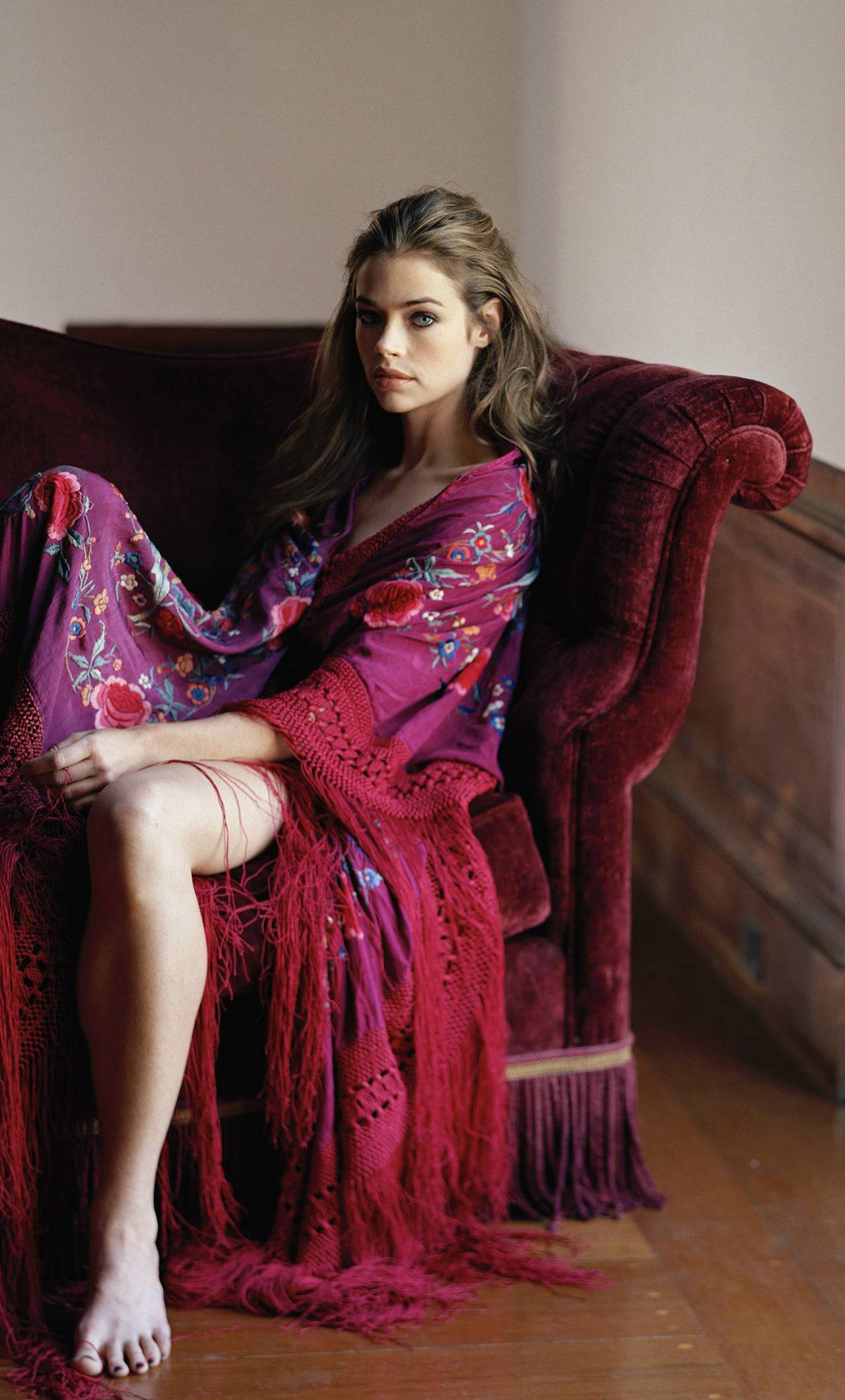 Denise Richards, vibrant purple floral robe, plush burgundy velvet armchair, Full HD Phone Wallpaper