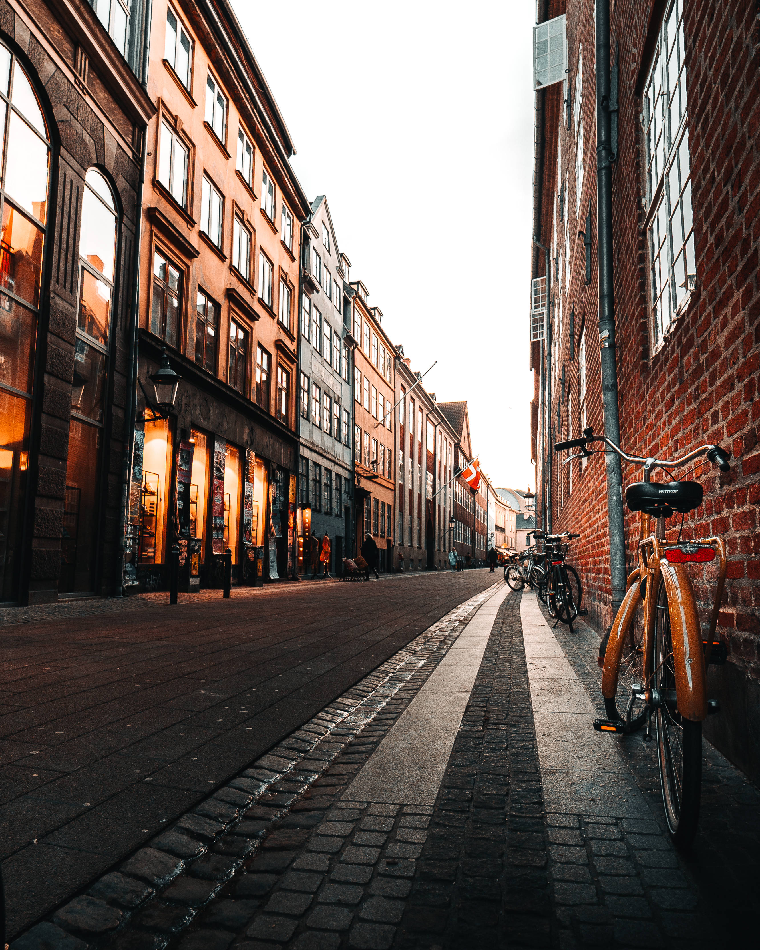 Denmark, cobblestone alleyway, historic brick buildings, 2K Phone Wallpaper