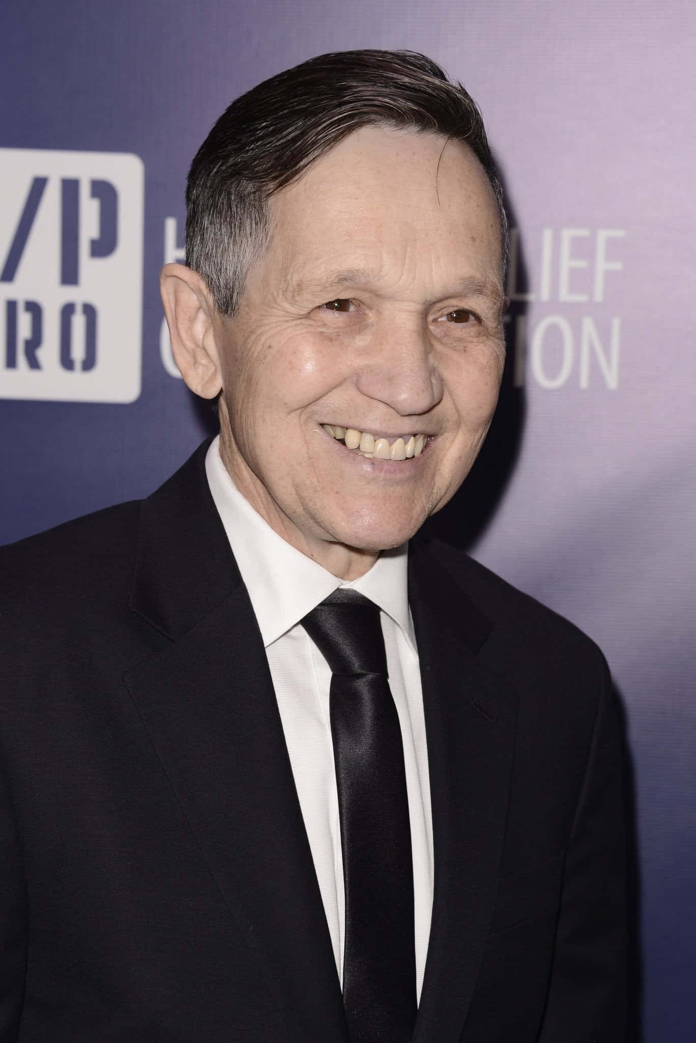 Dennis Kucinich, black suit and tie, purple event backdrop, Full HD Phone Wallpaper