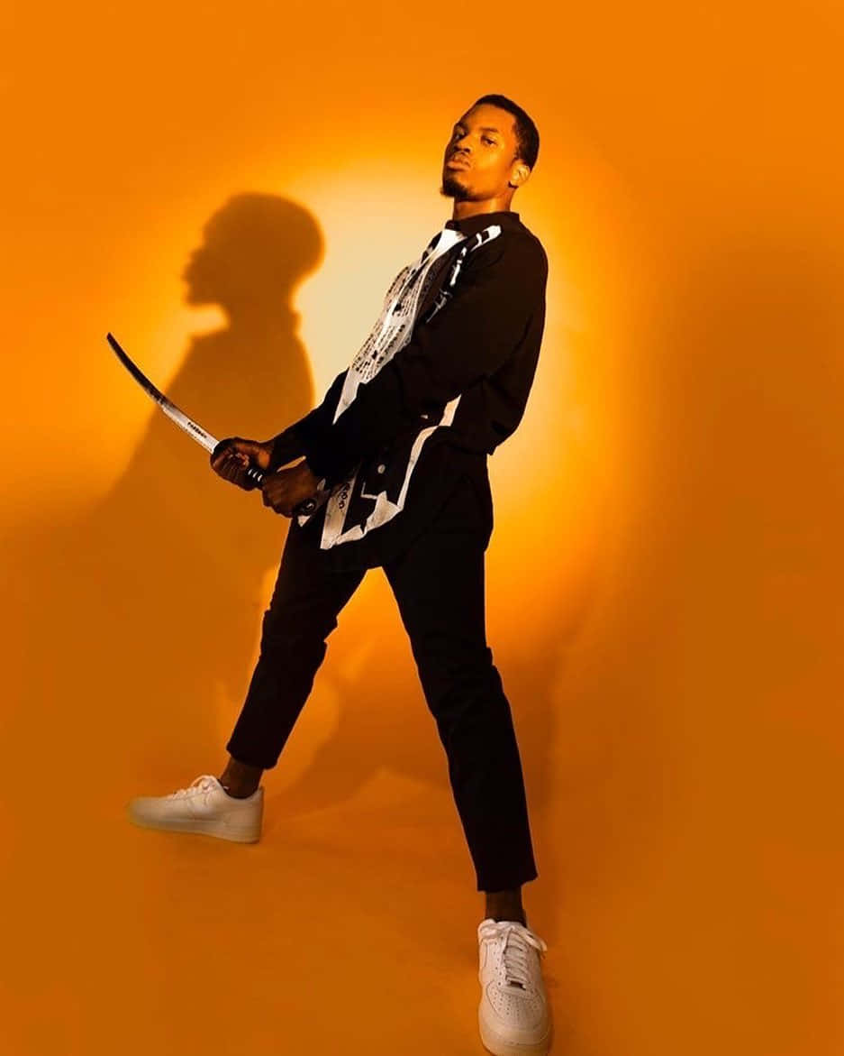 Denzel Curry, orange backdrop, curved sword, SD Phone Wallpaper