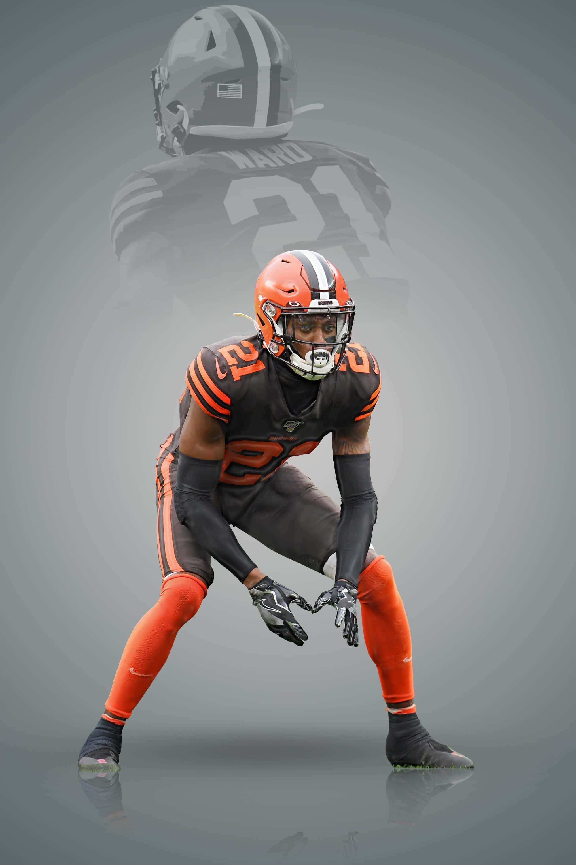 Denzel Ward, orange and brown uniform, crouches in a ready stance, 2K Phone Wallpaper