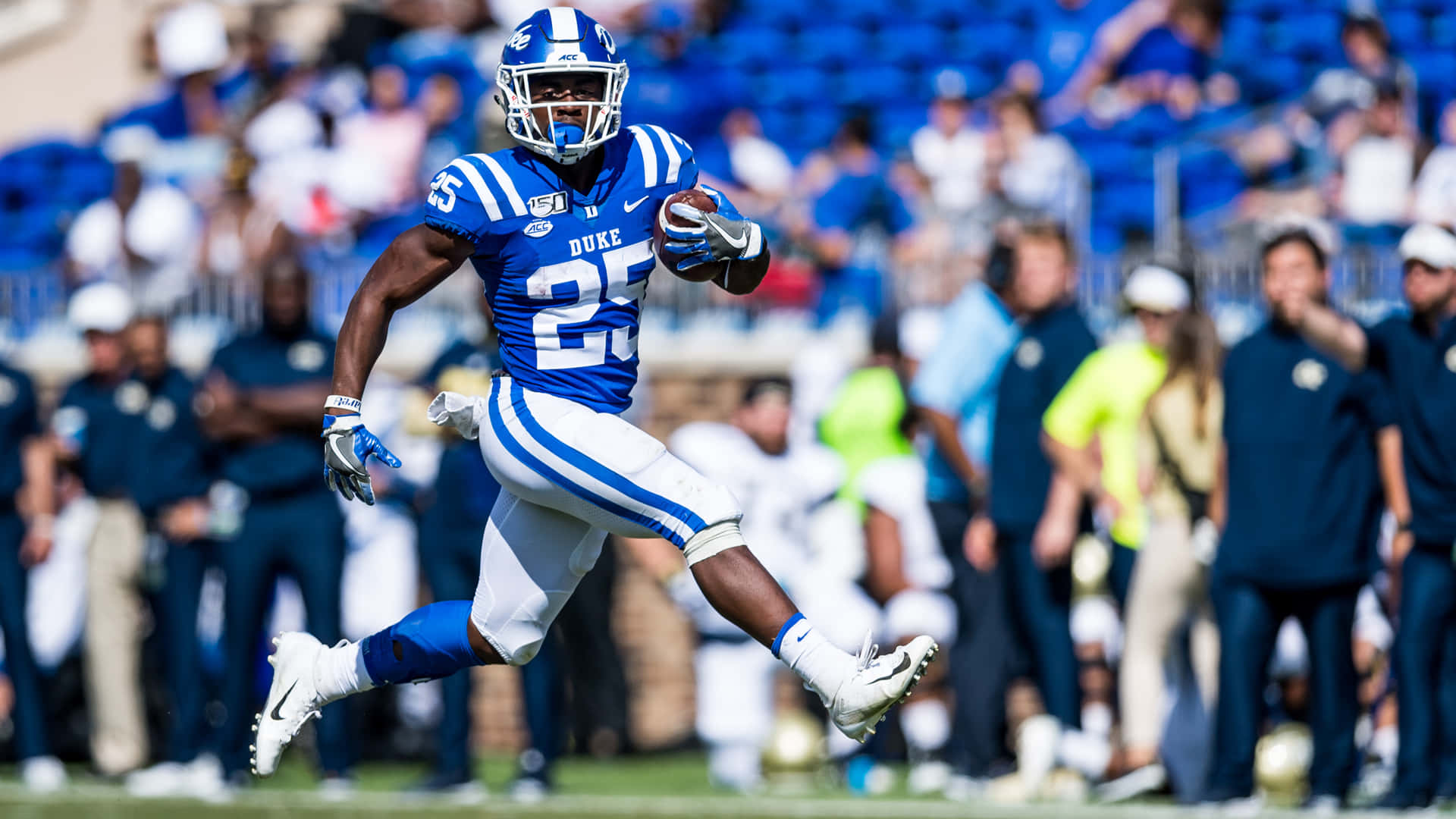 Duke football player, blue and white uniform, sprints with the ball downfield, Full HD Desktop Wallpaper