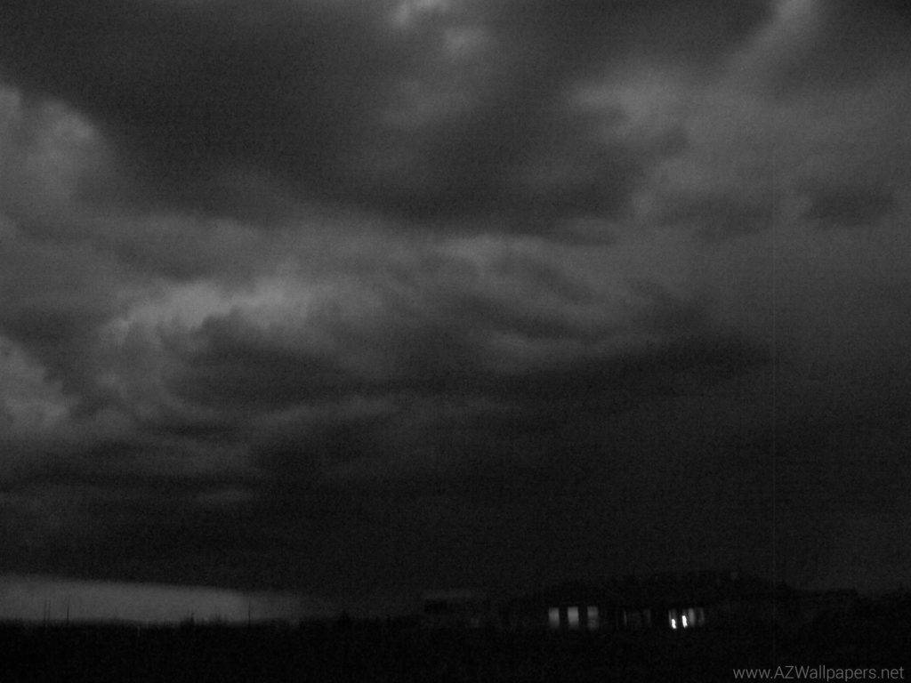 monochrome storm clouds, dark landscape, faint glowing windows, SD Desktop Wallpaper