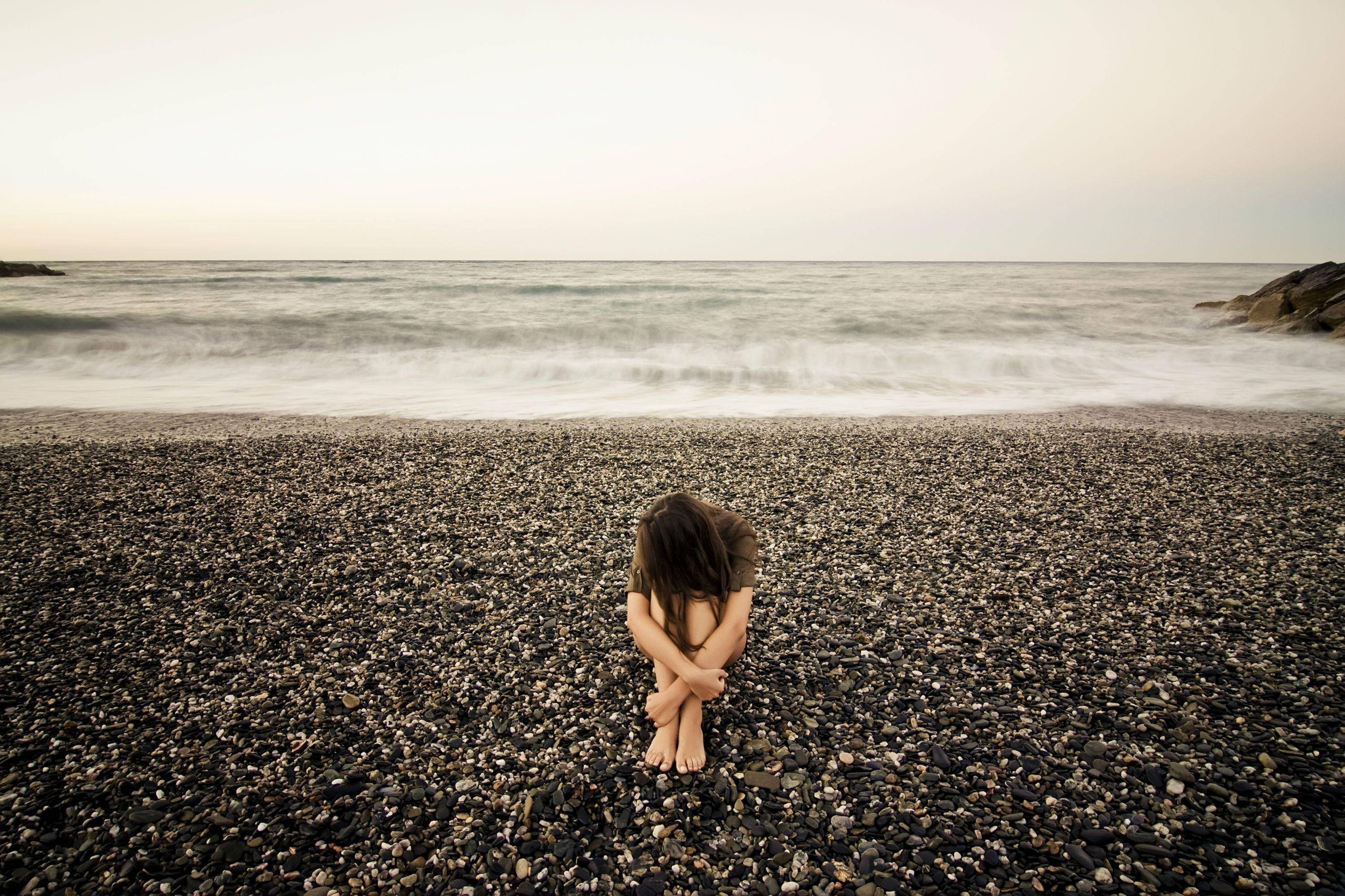depressed girl, pebbled beach, gentle waves, 2K Desktop Wallpaper