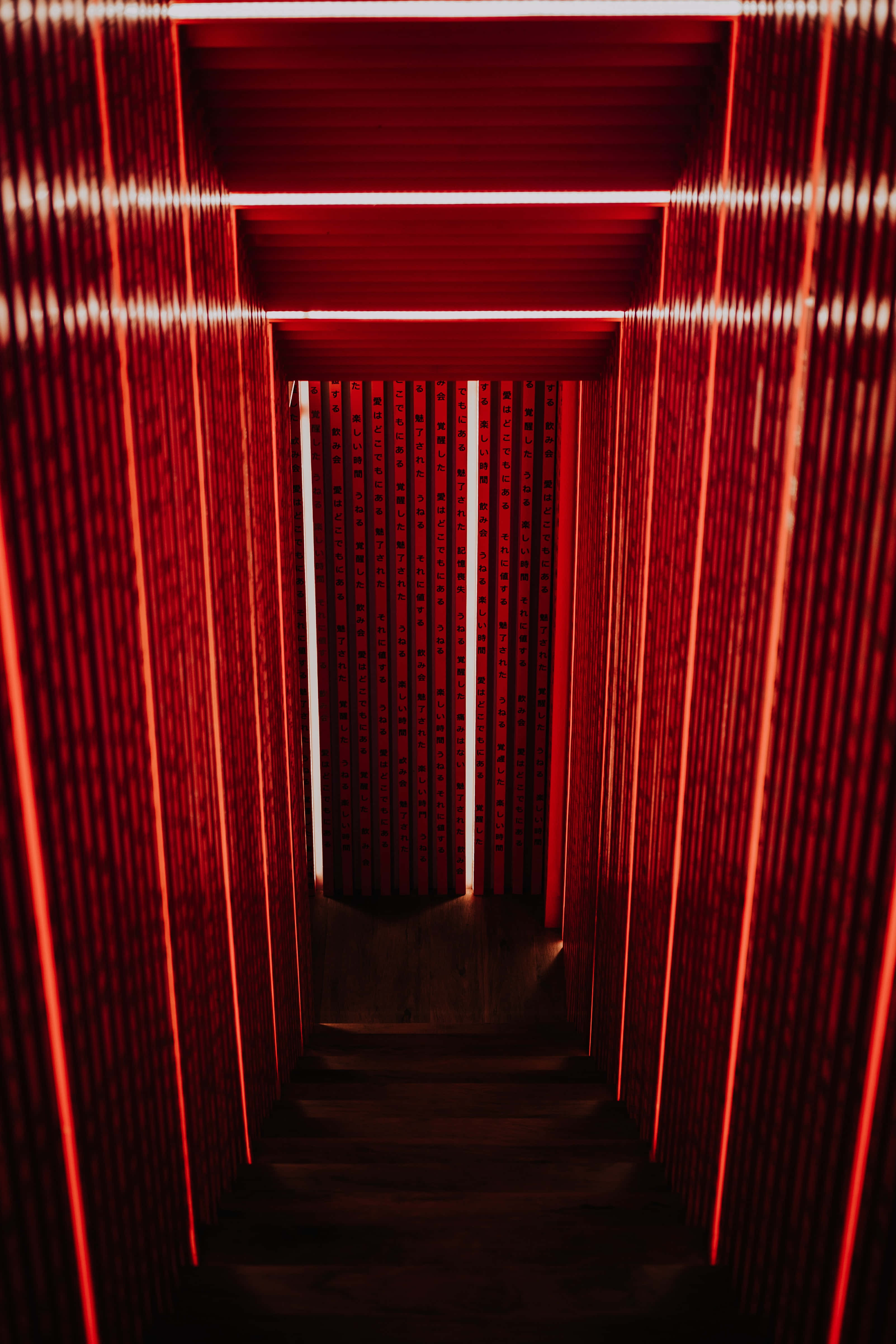 Simple iPhone, glowing red vertical slats, narrow staircase, 4K Phone Wallpaper