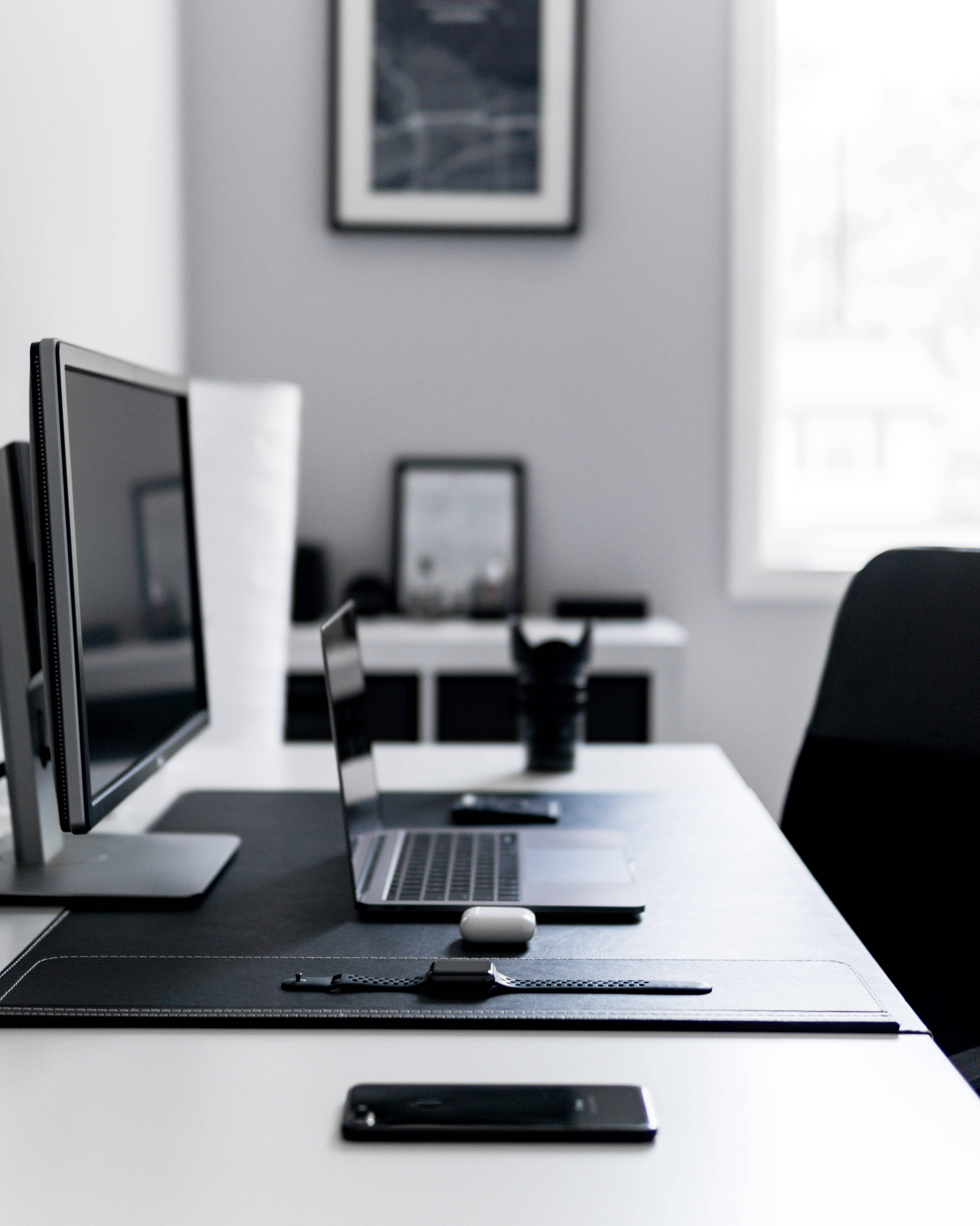 Sleek iPhone, laptop monitor, chair, 4K Phone Wallpaper