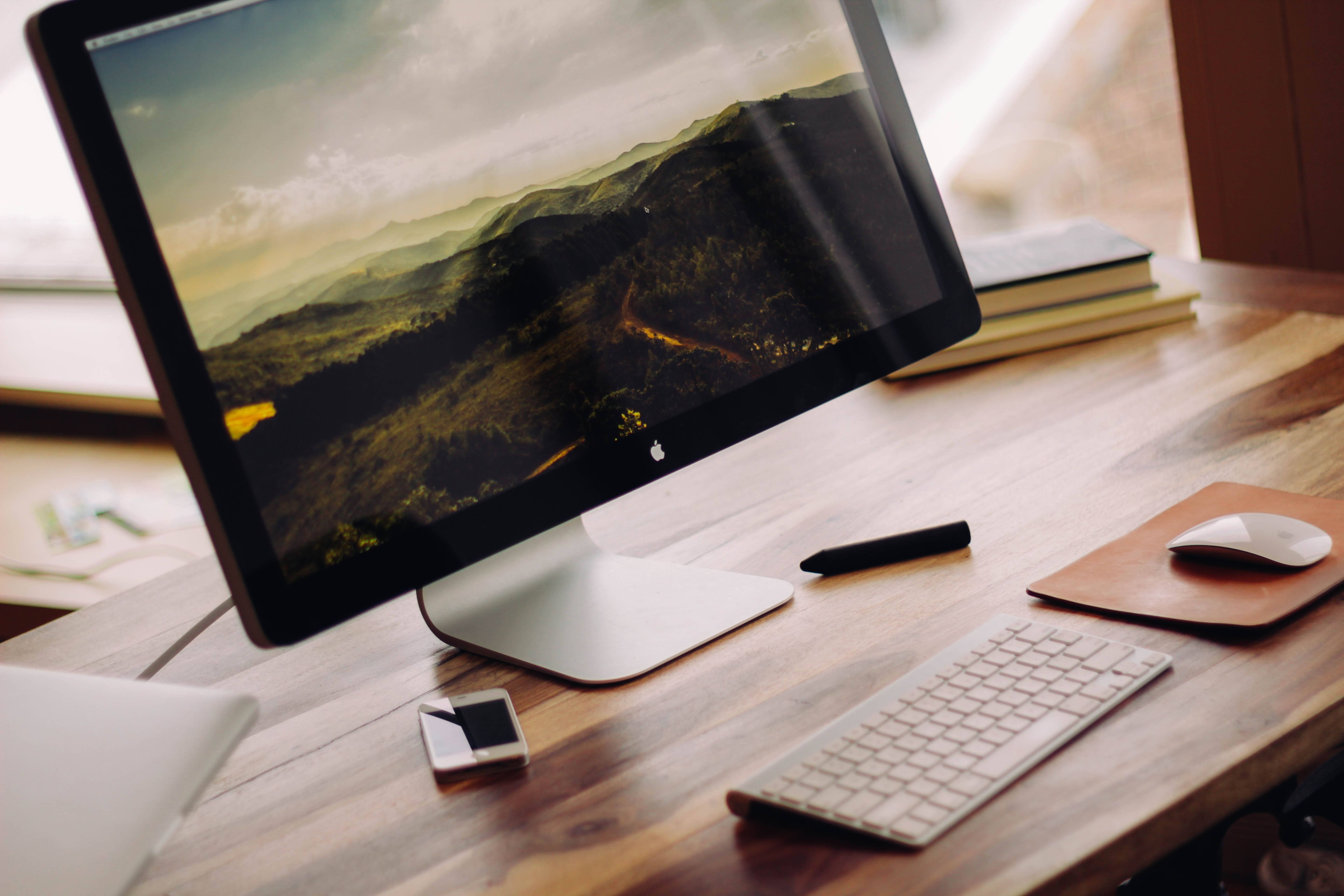 iMac, wooden desk, mountainous landscape wallpaper, 5K Desktop Wallpaper