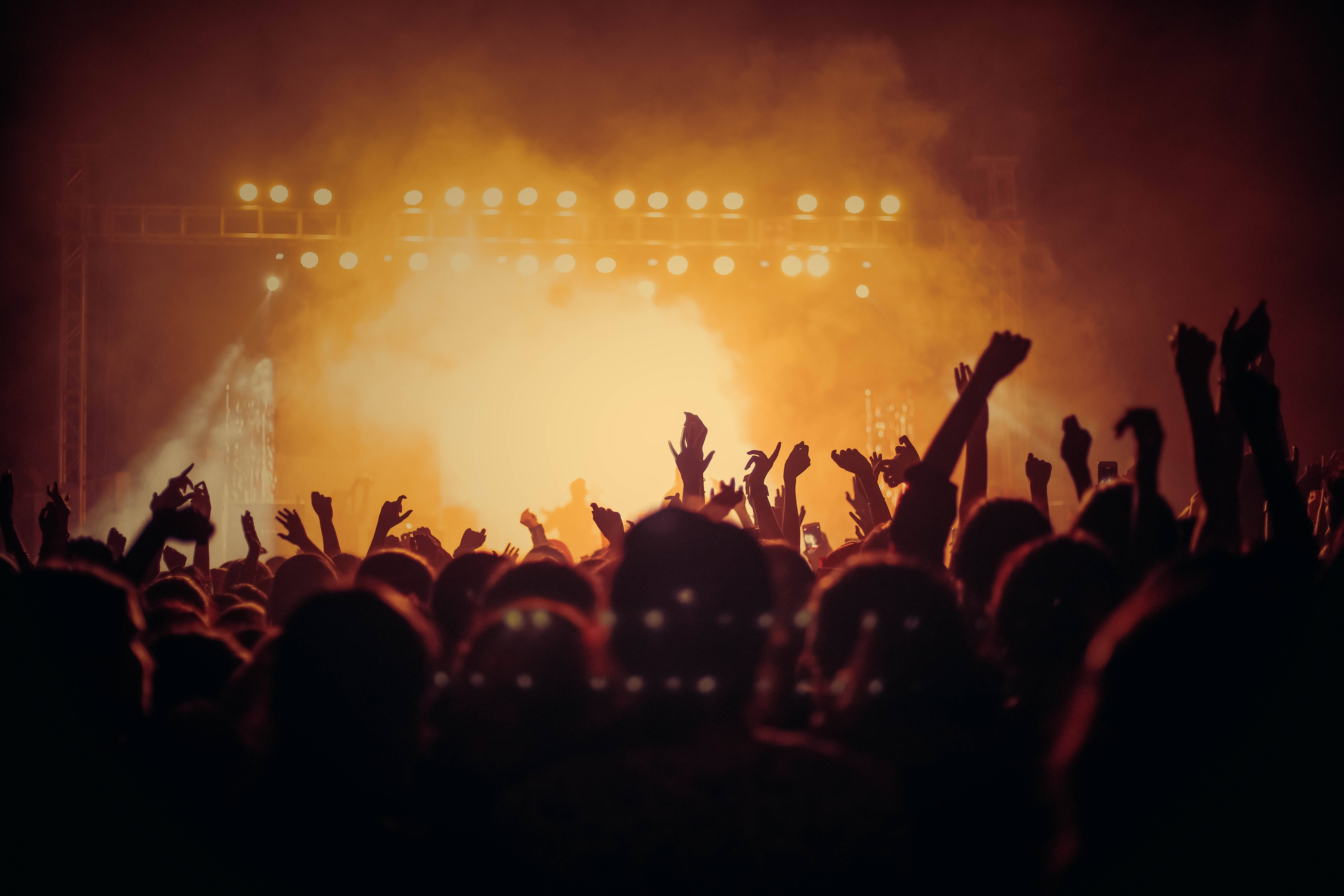 Concert Desktop Computer, glowing orange stage lights, haze, 5K Desktop Wallpaper