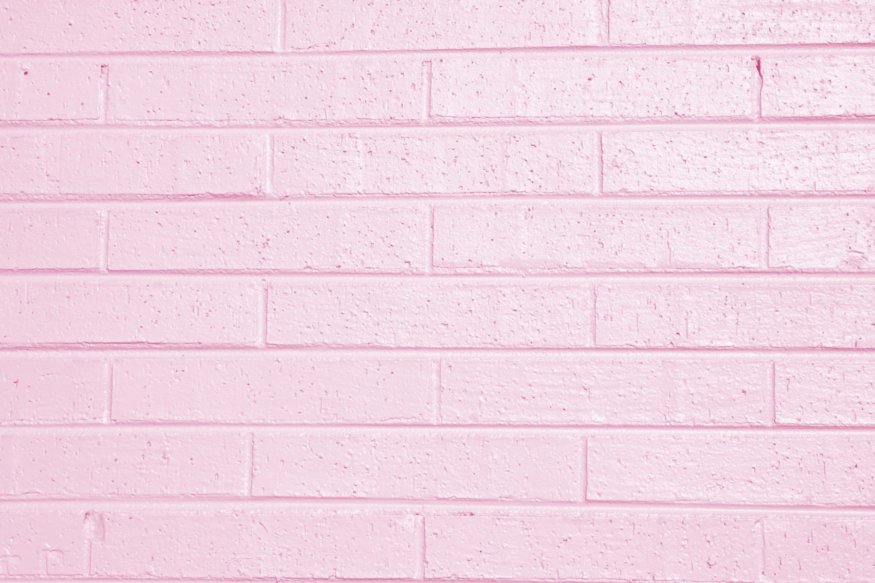 pink-painted brick wall, visible mortar lines, subtle texture, 2K Desktop Wallpaper