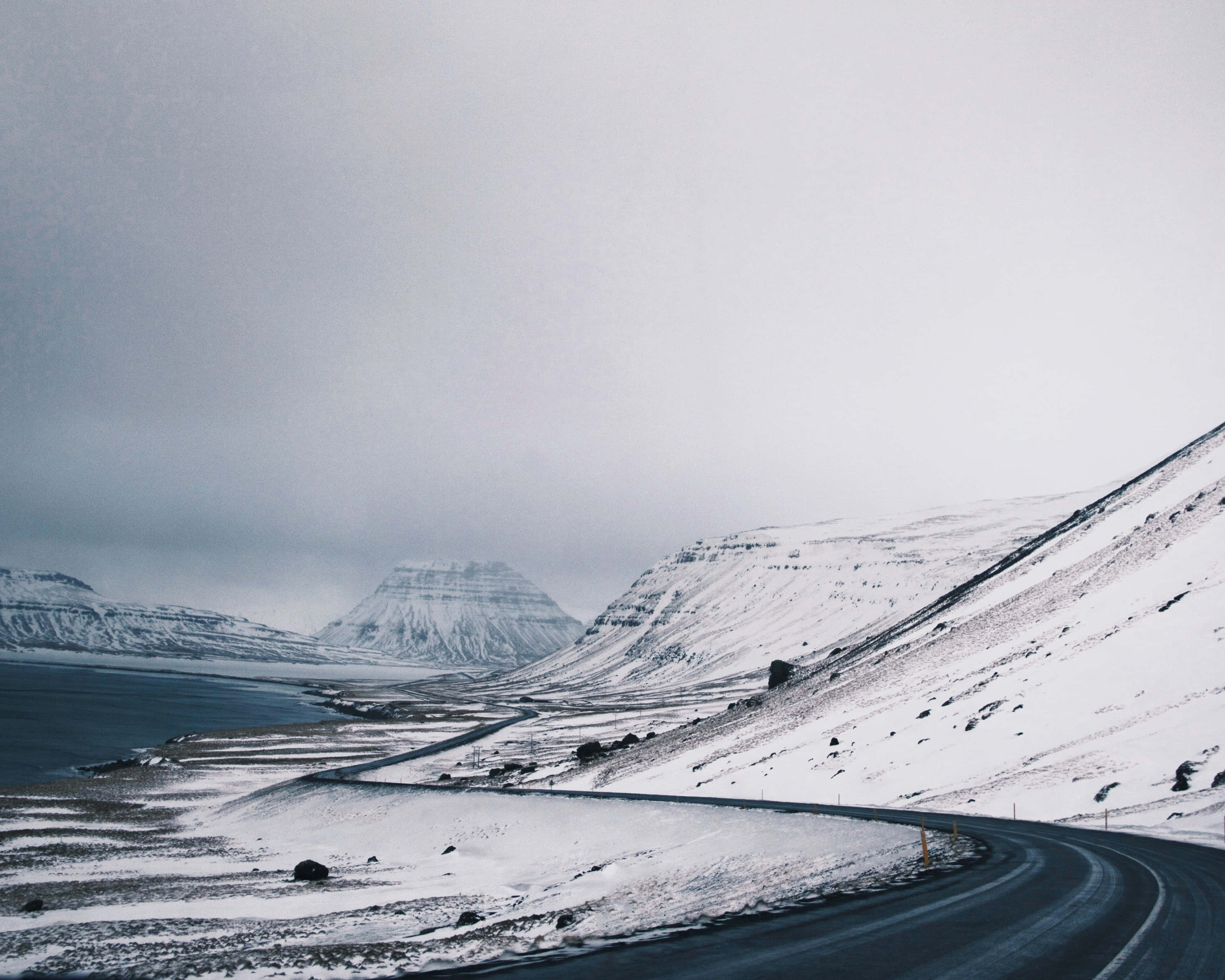 Desolate, coastal mountain road, Icelandic landscape, 2K Desktop Wallpaper