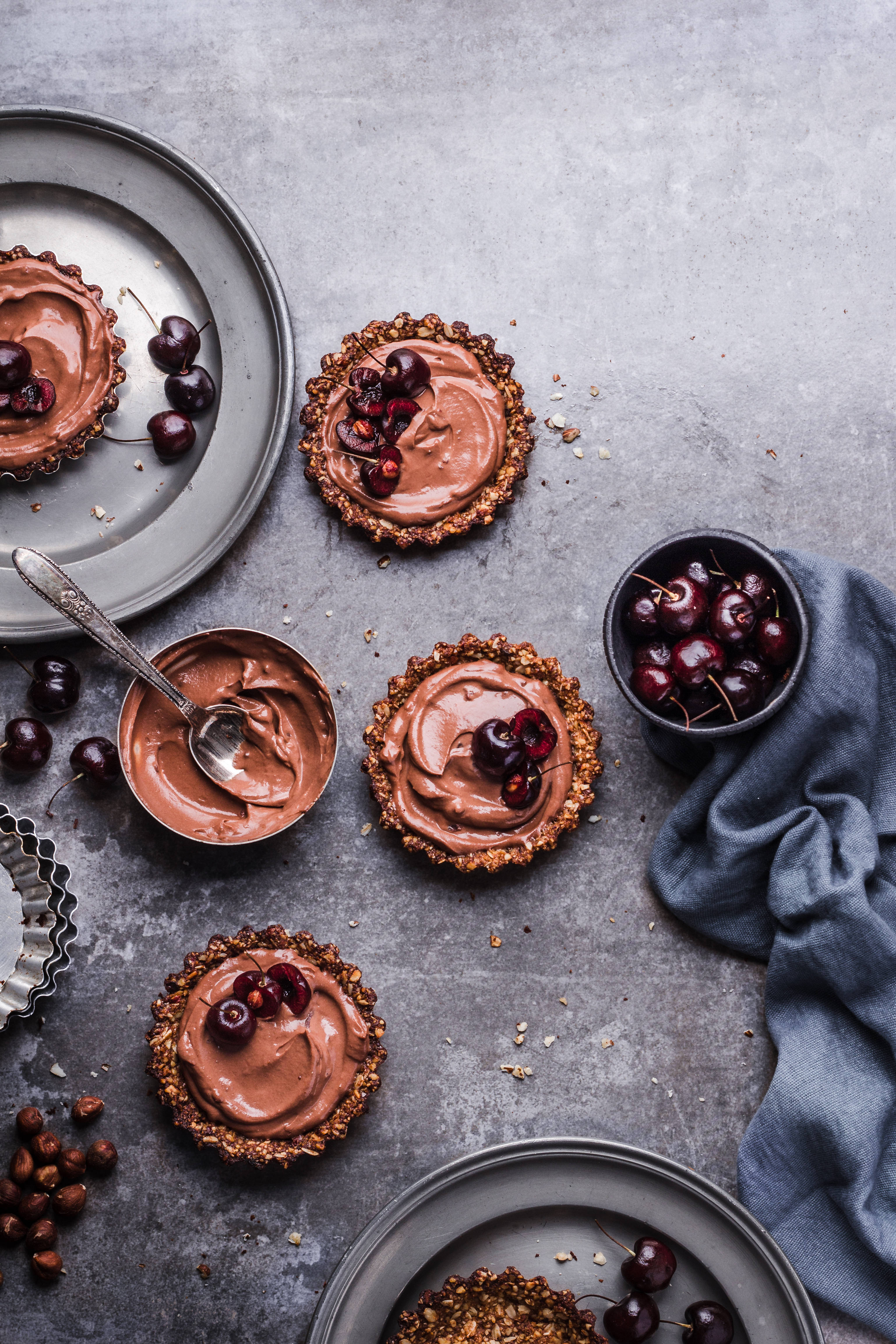 chocolate tarts, glossy cherries, textured gray surface, 4K Phone Wallpaper