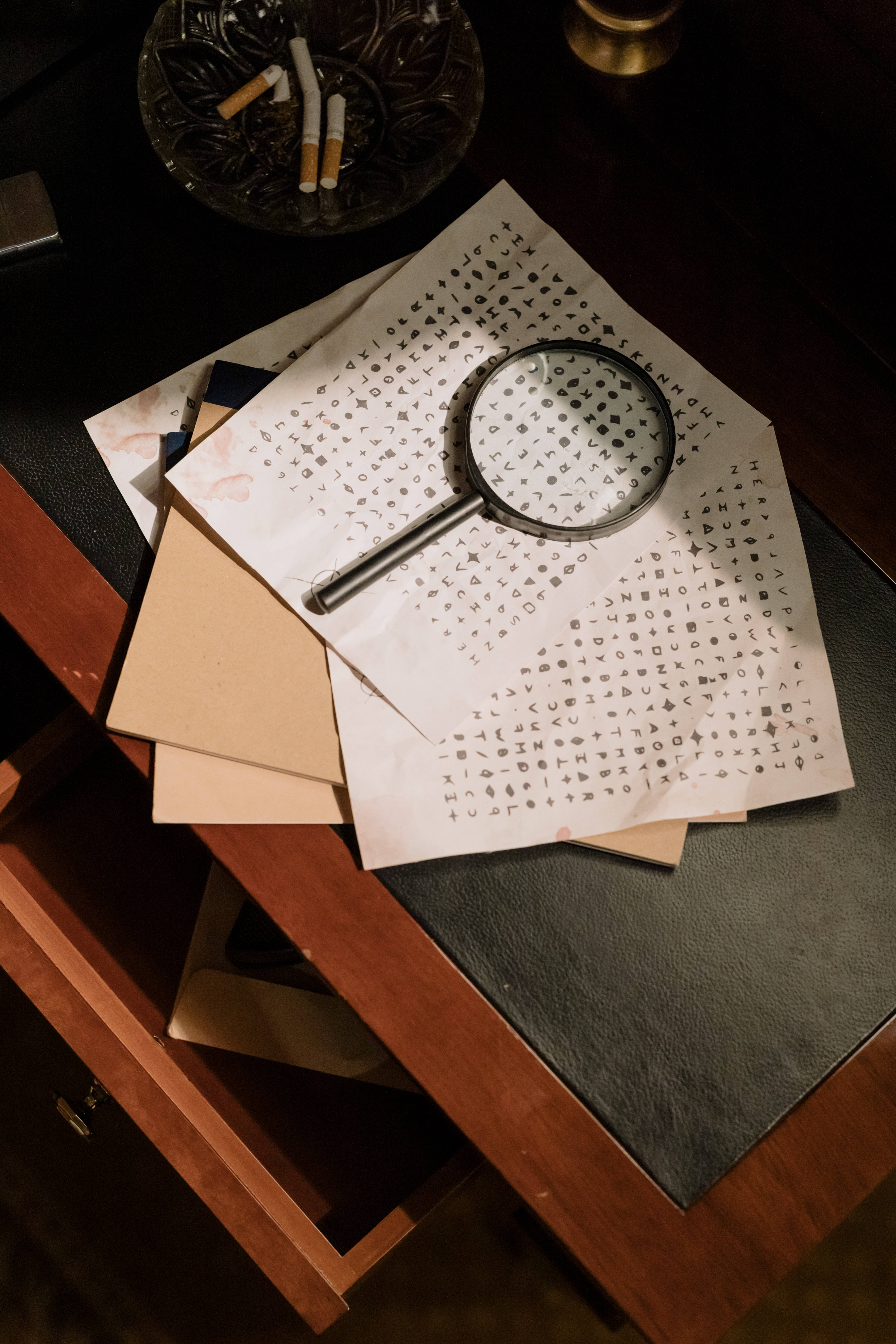 magnifying glass, handwritten symbols, dark wooden desk, 5K Phone Wallpaper