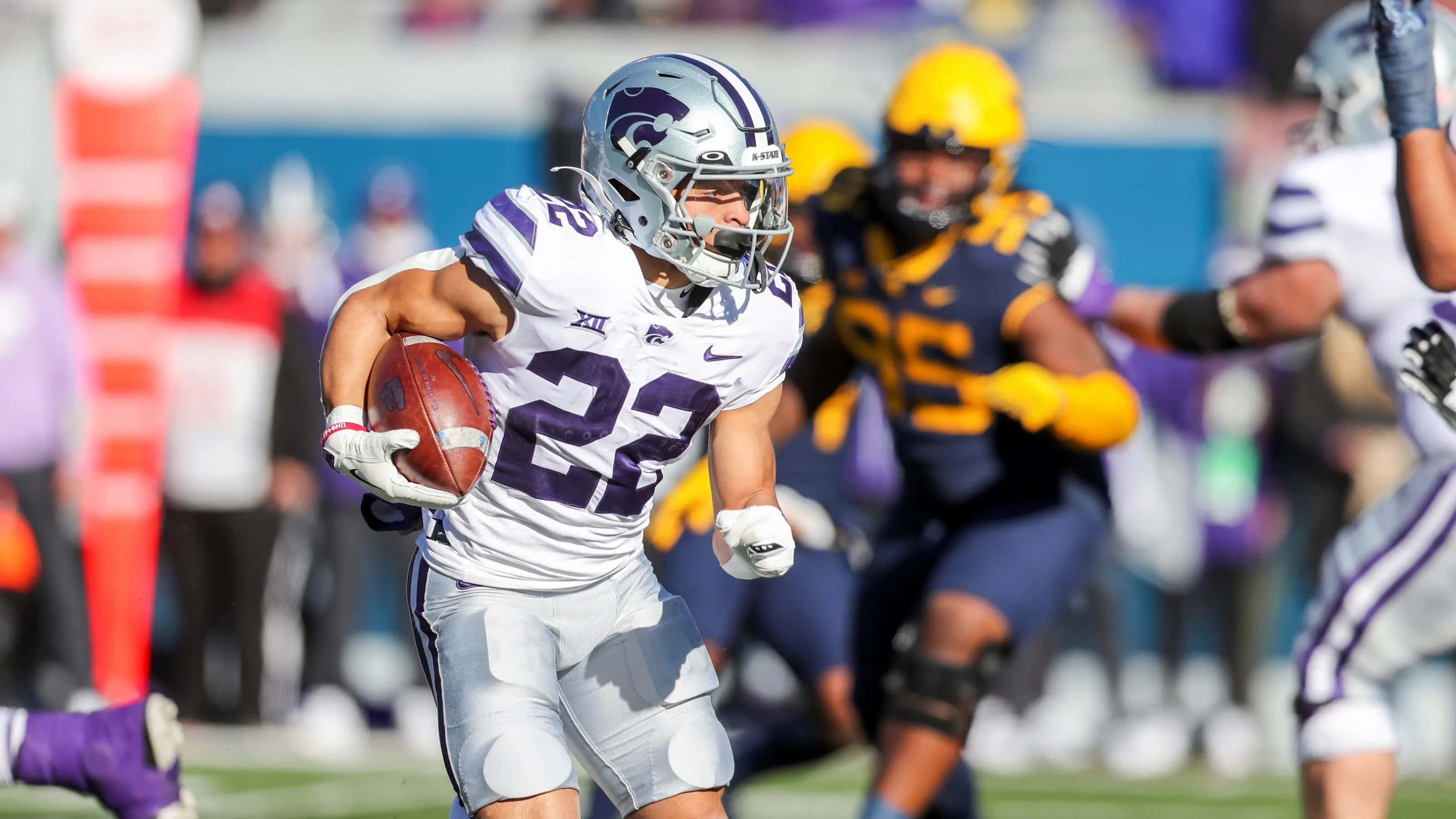 Deuce Vaughn, white and purple gear, sunny field, 2K Desktop Wallpaper