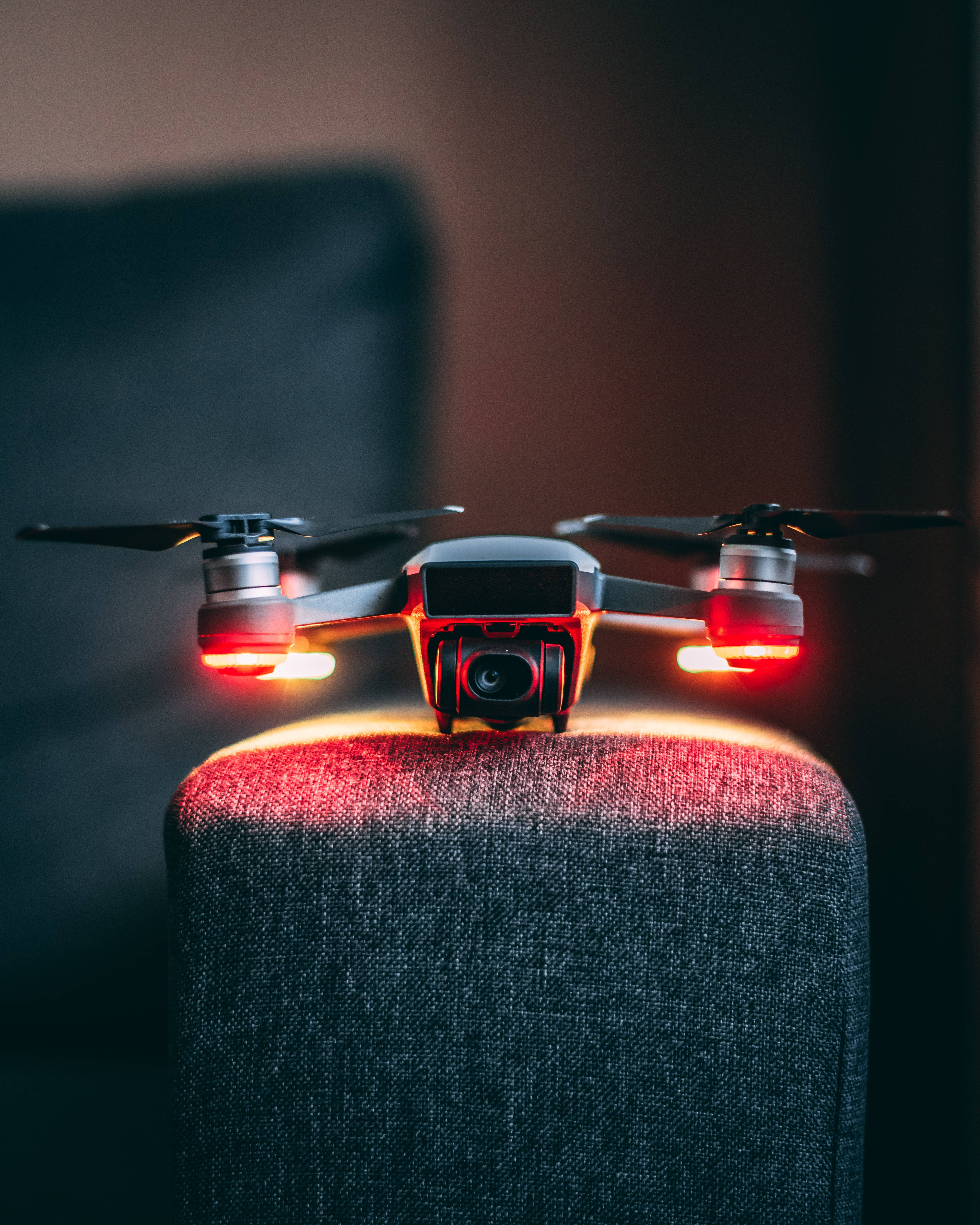 drone, armchair, glowing red lights, 5K Phone Wallpaper