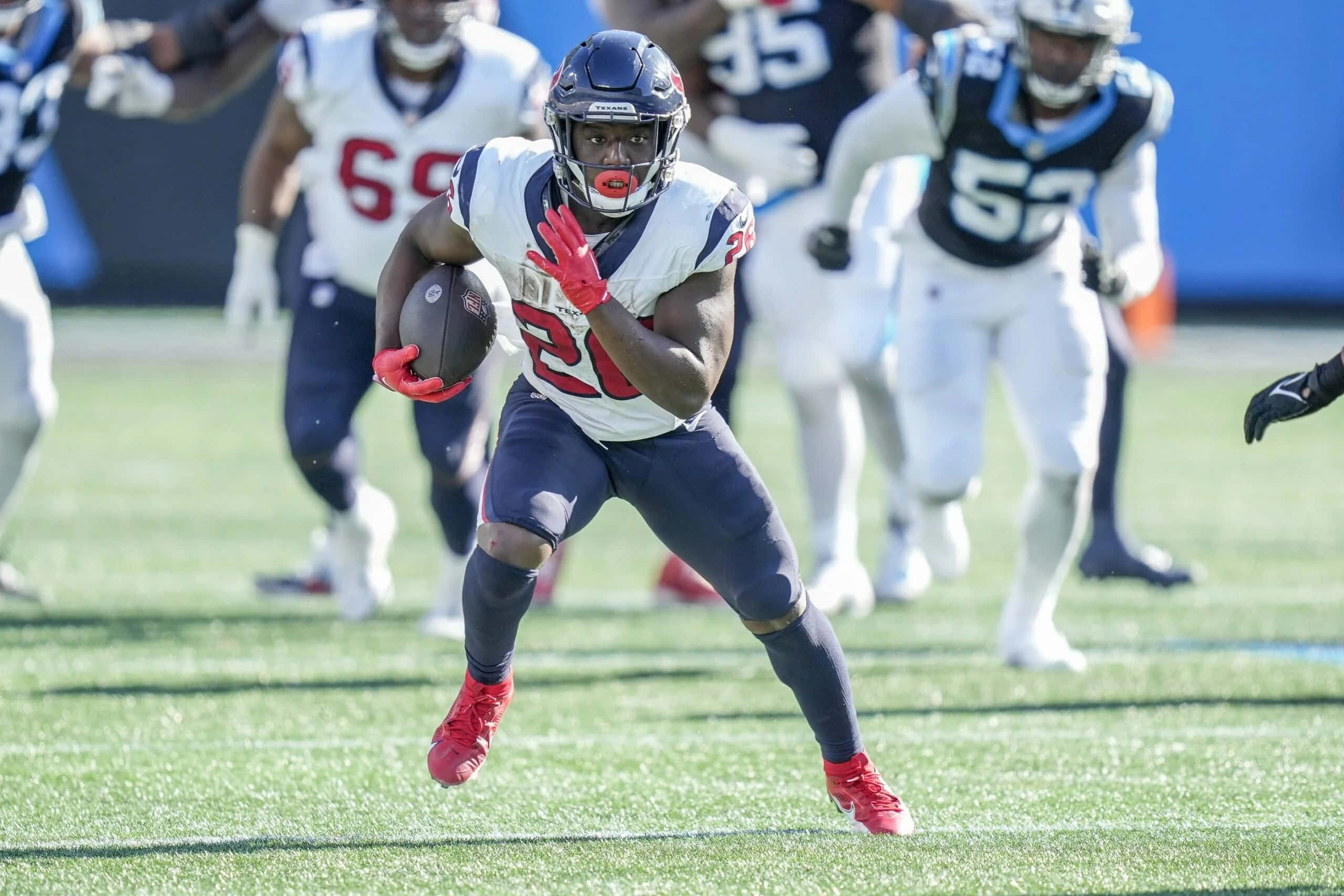 Devin Singletary, white and navy uniform, sunlit green field, 2K Desktop Wallpaper