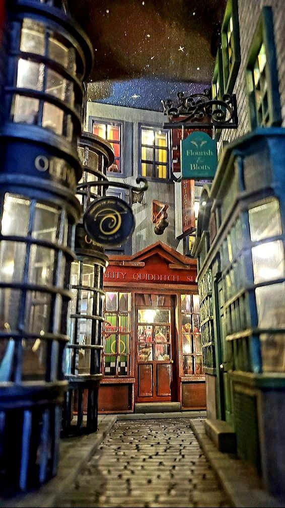 Diagon Alley, cobblestone alley, glowing blue lanterns, SD Phone Wallpaper