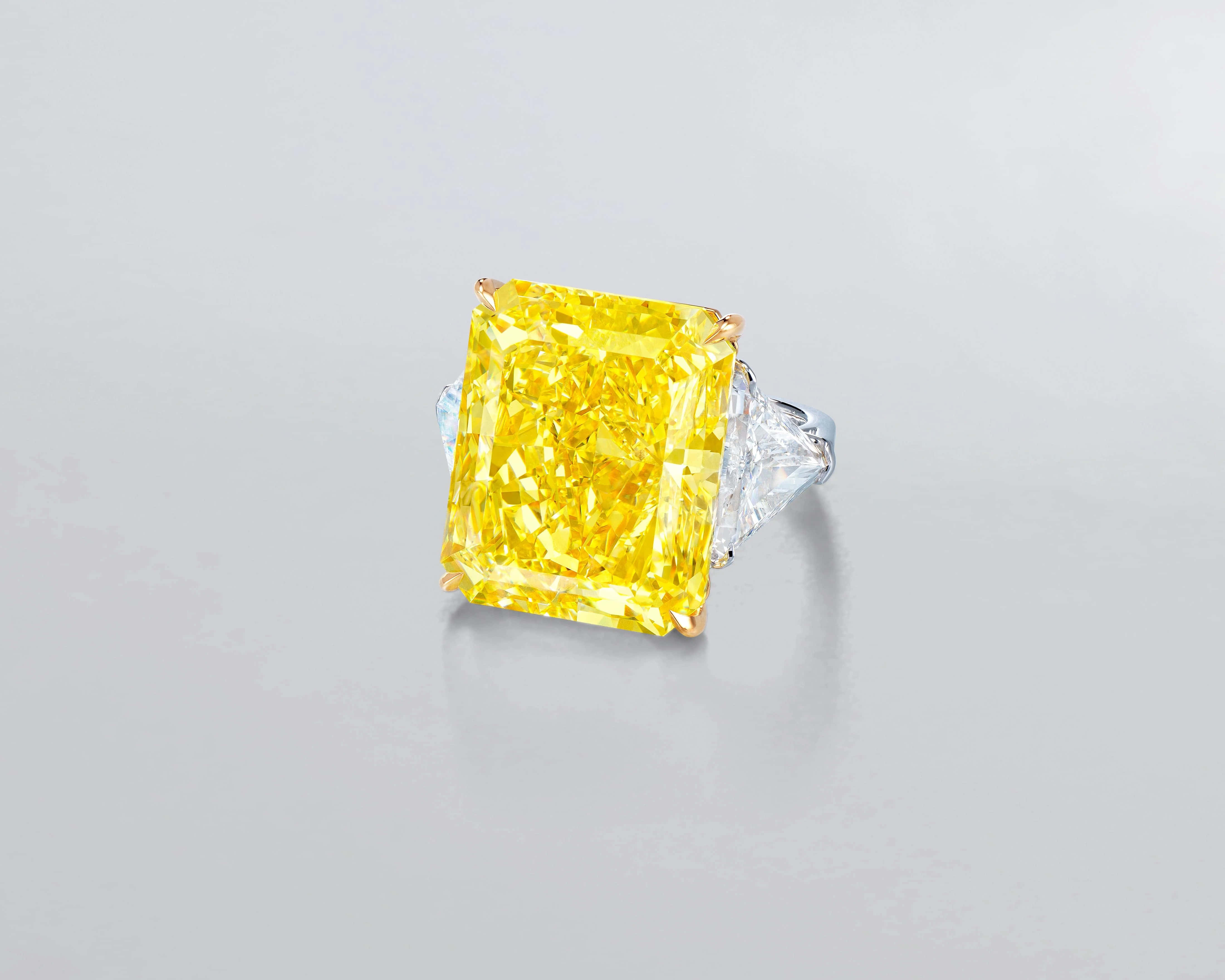 yellow emerald-cut diamond, clear triangular side stones, soft gray background, 4K Desktop Wallpaper