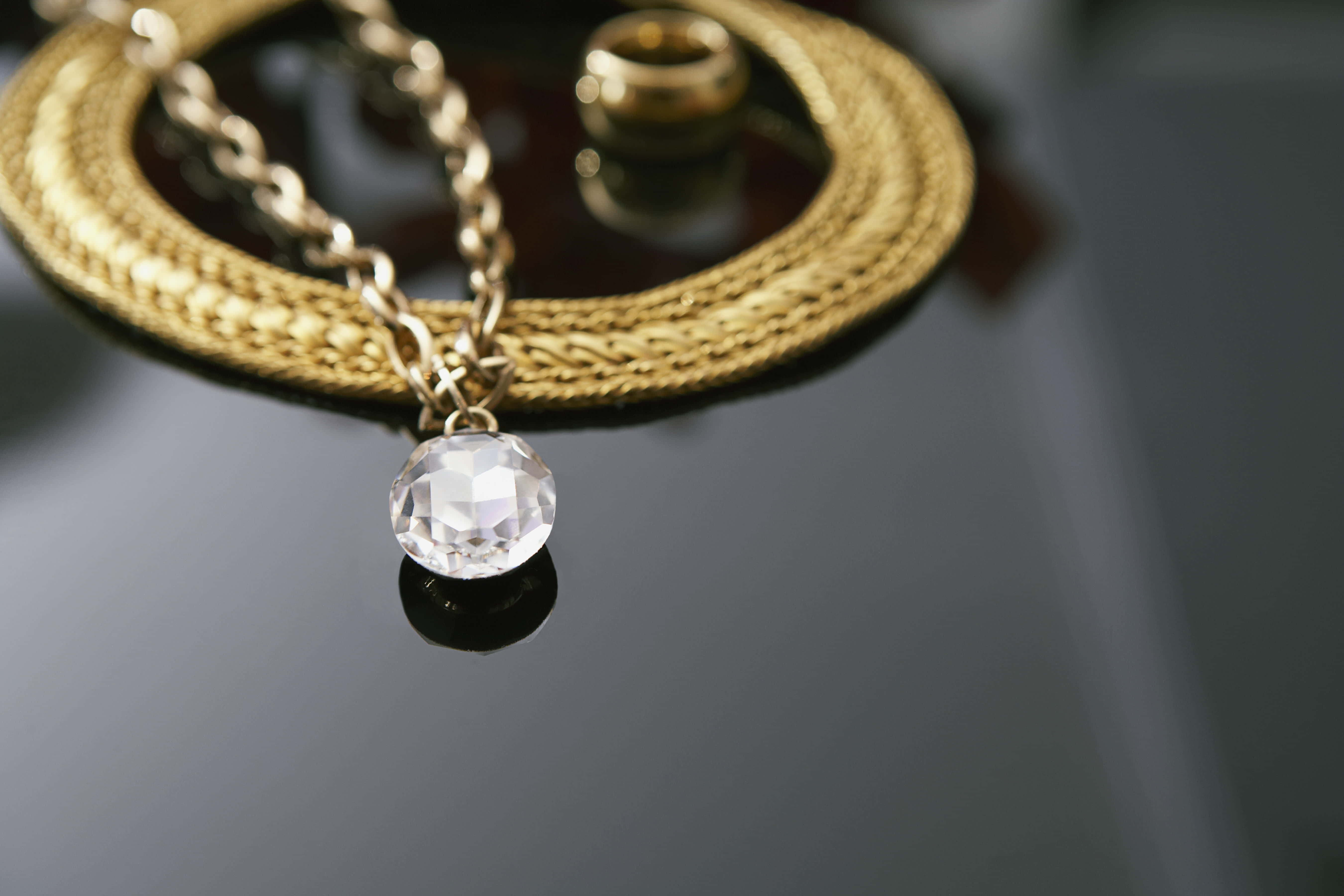gold chain necklace, faceted crystal pendant, dark reflective surface, 5K Desktop Wallpaper