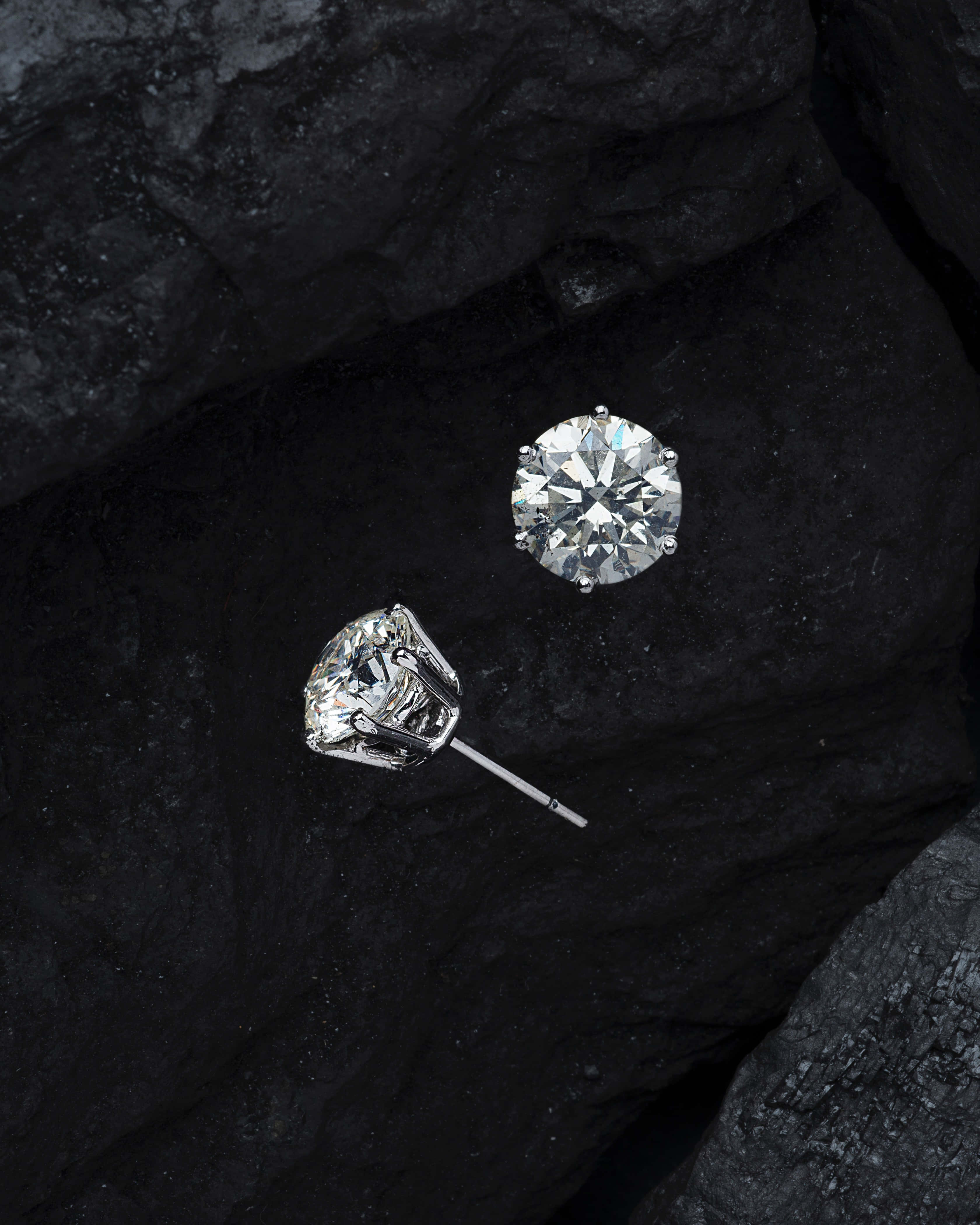 diamond stud earrings, sparkling diamond, dark textured rock surface, 4K Phone Wallpaper