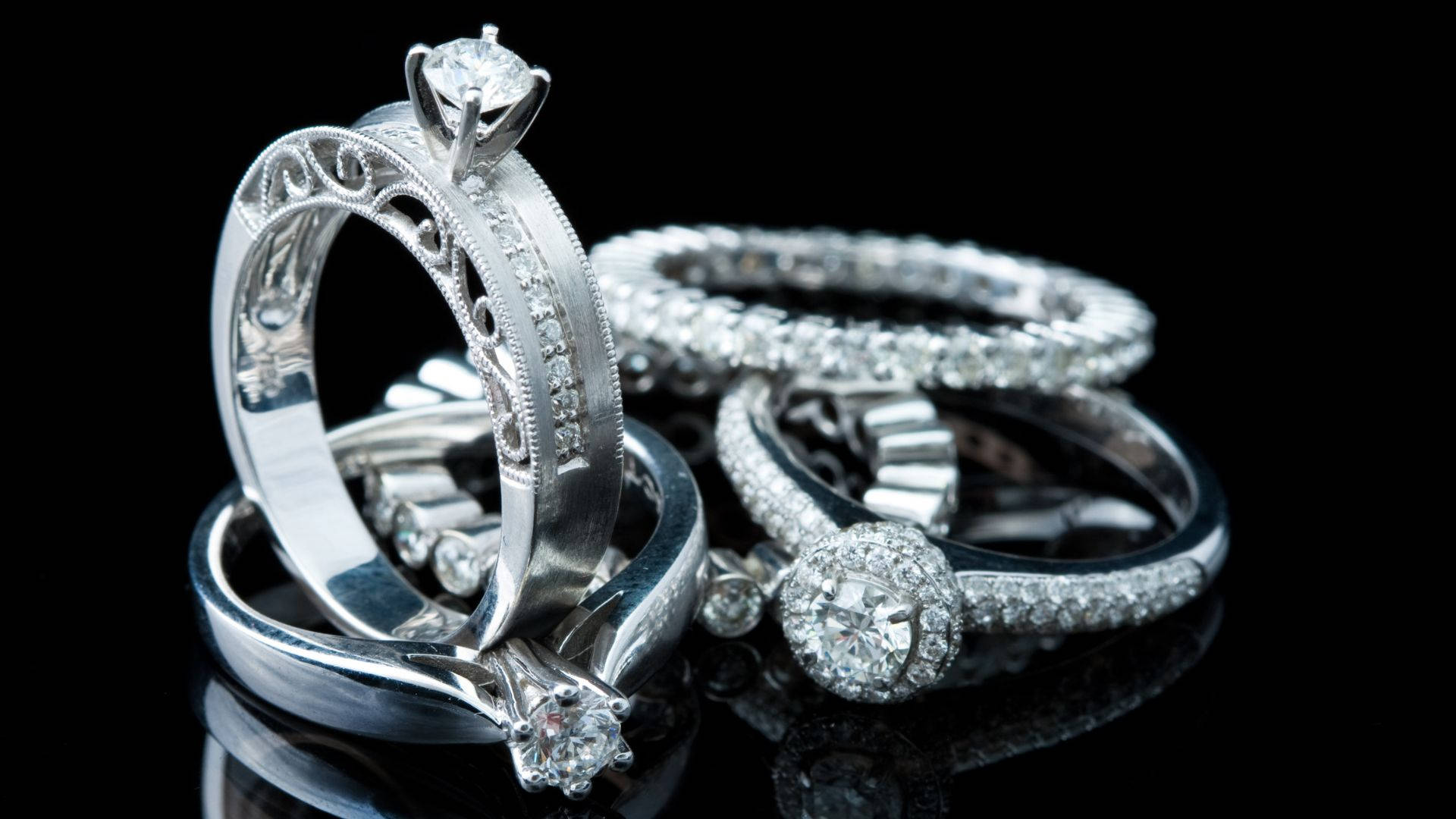 diamond rings, intricate settings, stark black reflective surface, Full HD Desktop Wallpaper