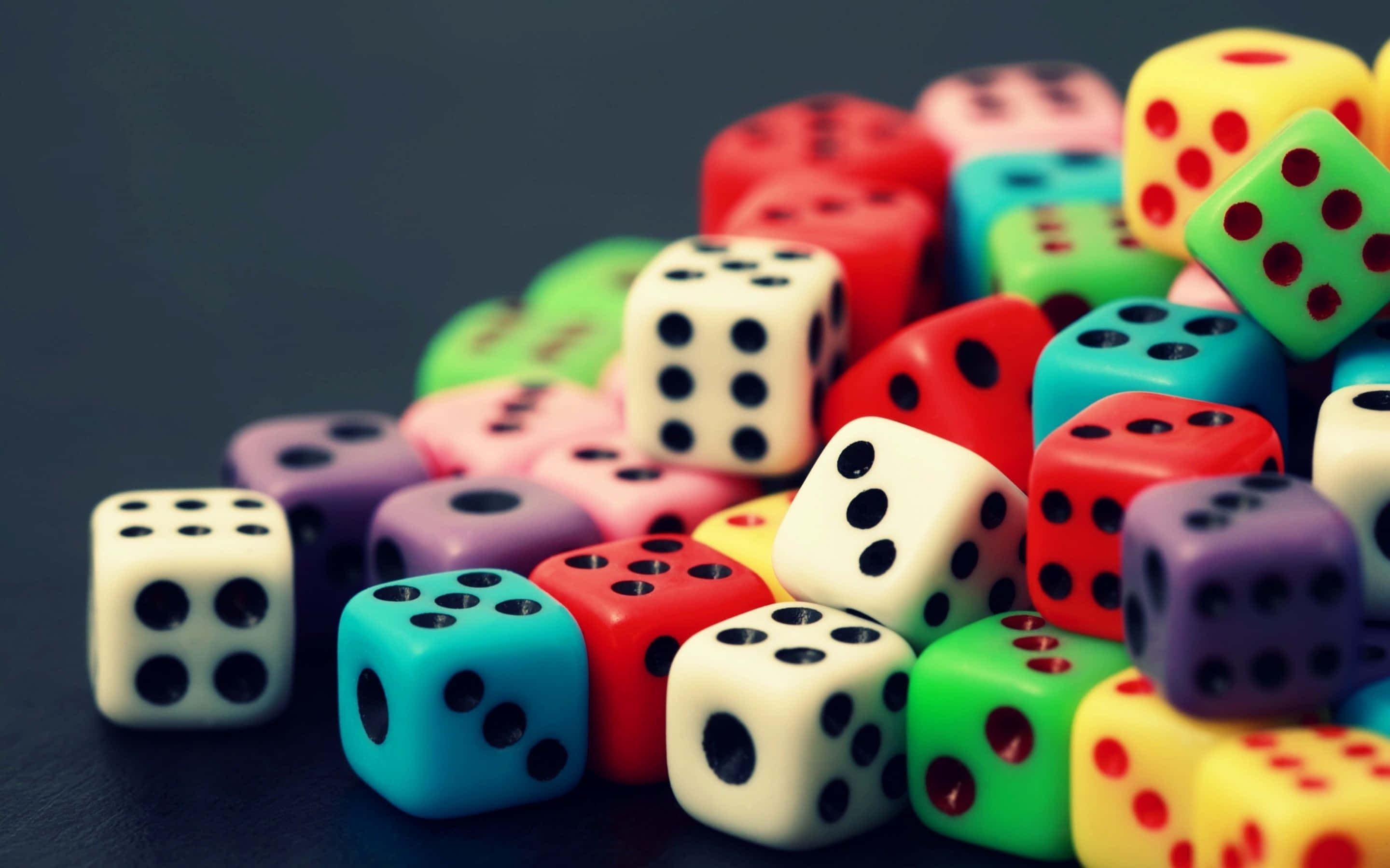 colorful dice, vibrant pile, dark surface, 2K Desktop Wallpaper