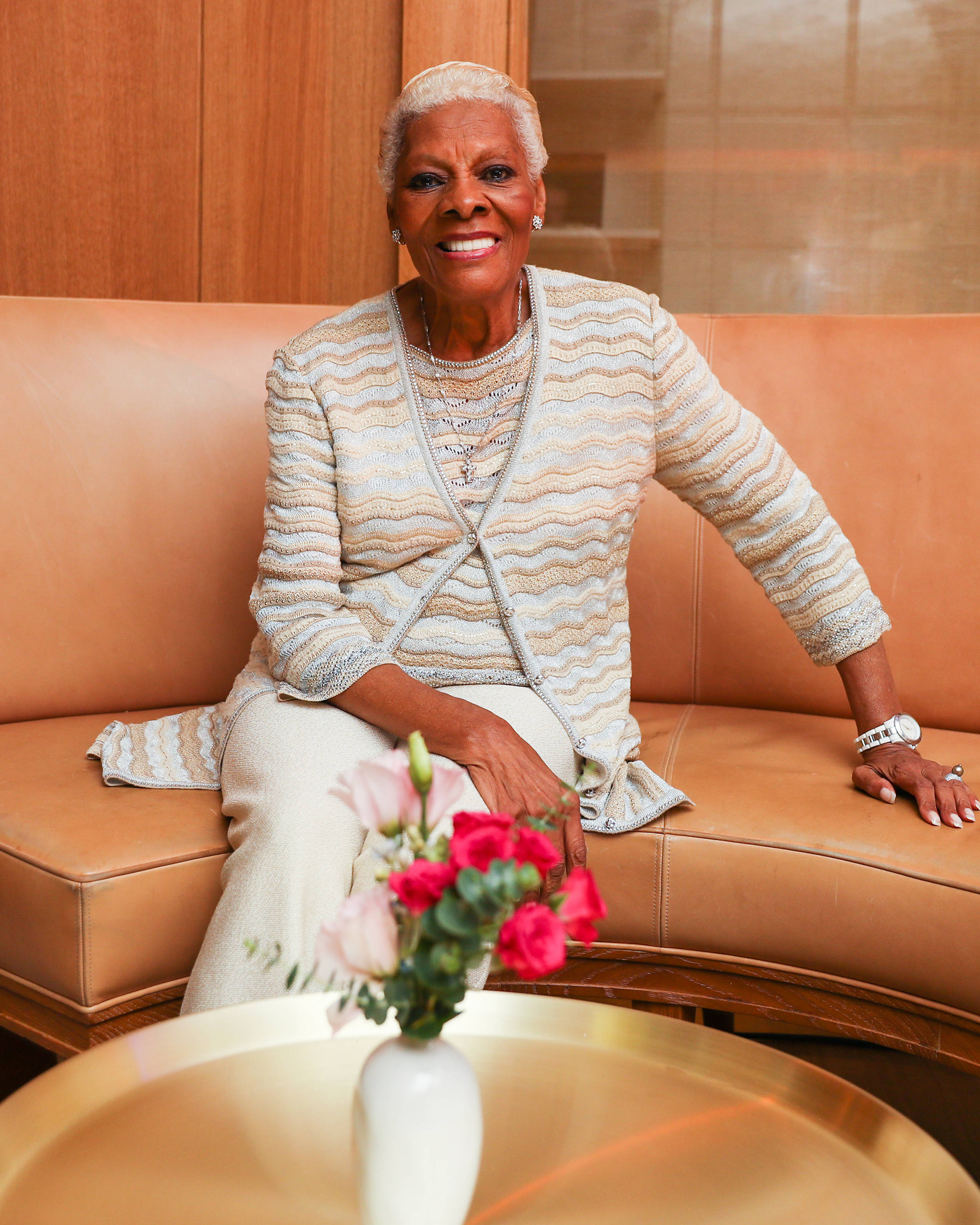 Dionne Warwick, tan leather couch, vase of pink and red roses, 2K Phone Wallpaper