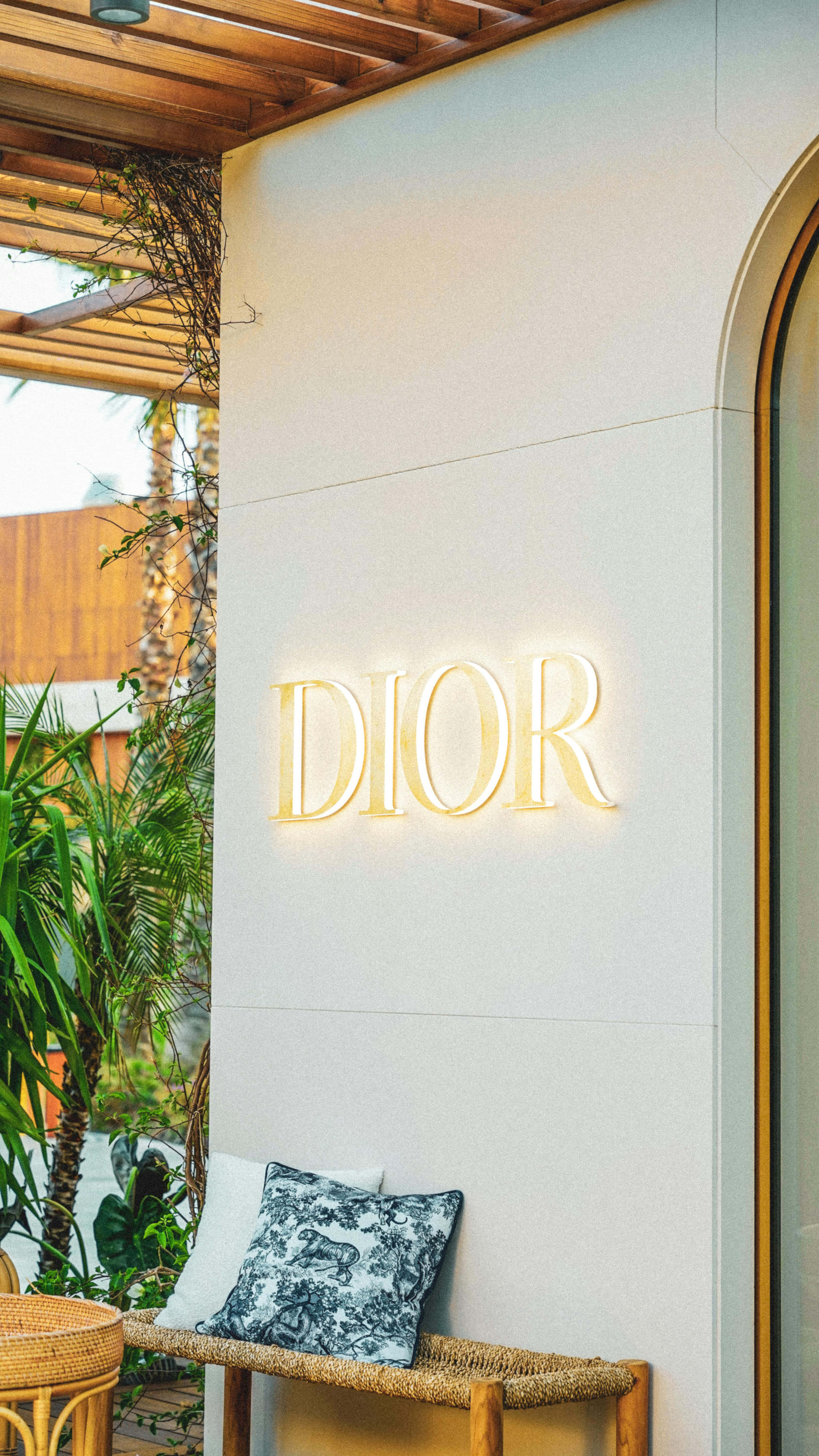 Dior, golden glowing Dior logo, white wall, 5K Phone Wallpaper