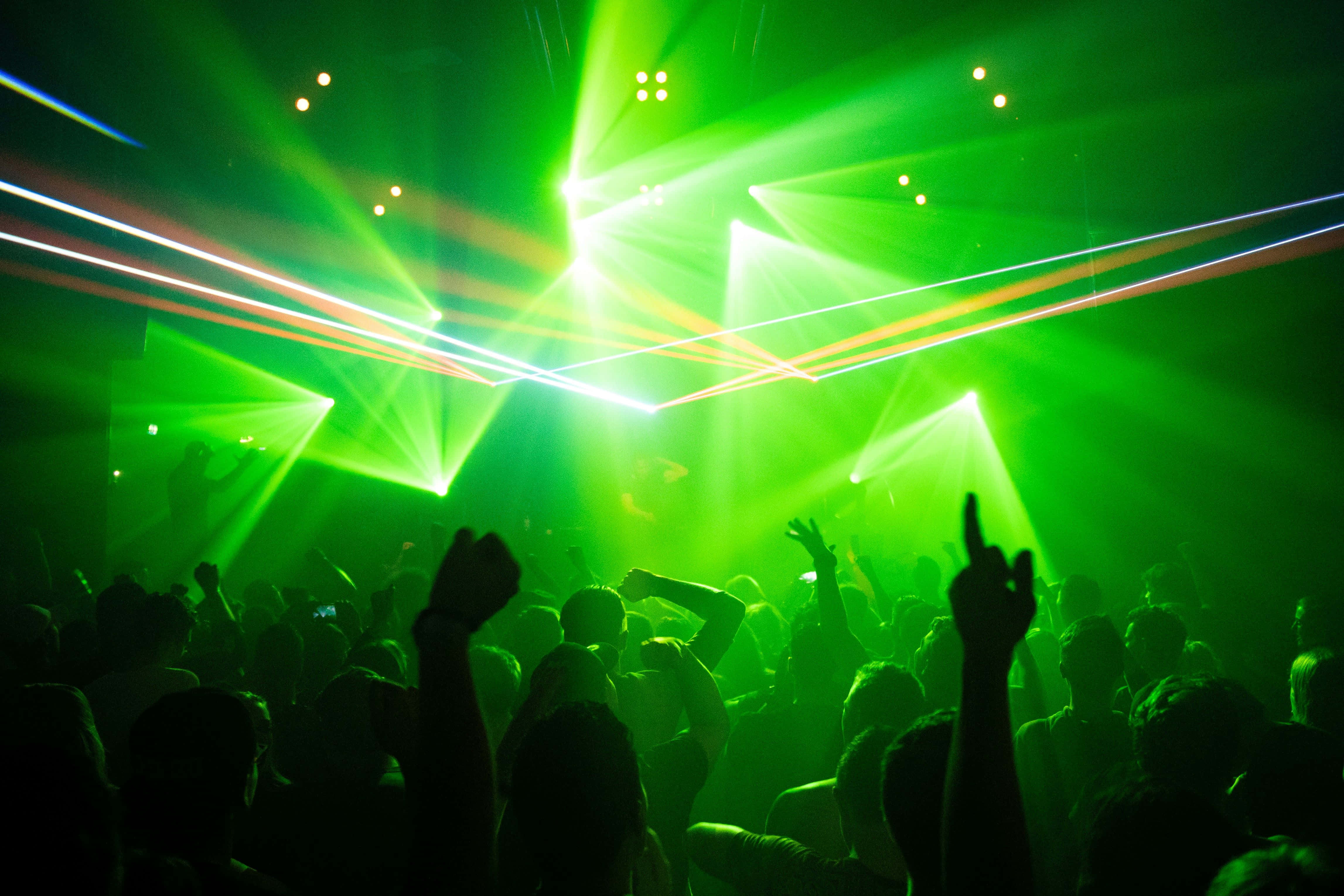 vibrant green laser lights, pulsating nightclub scene, crowd silhouettes, 4K Desktop Wallpaper