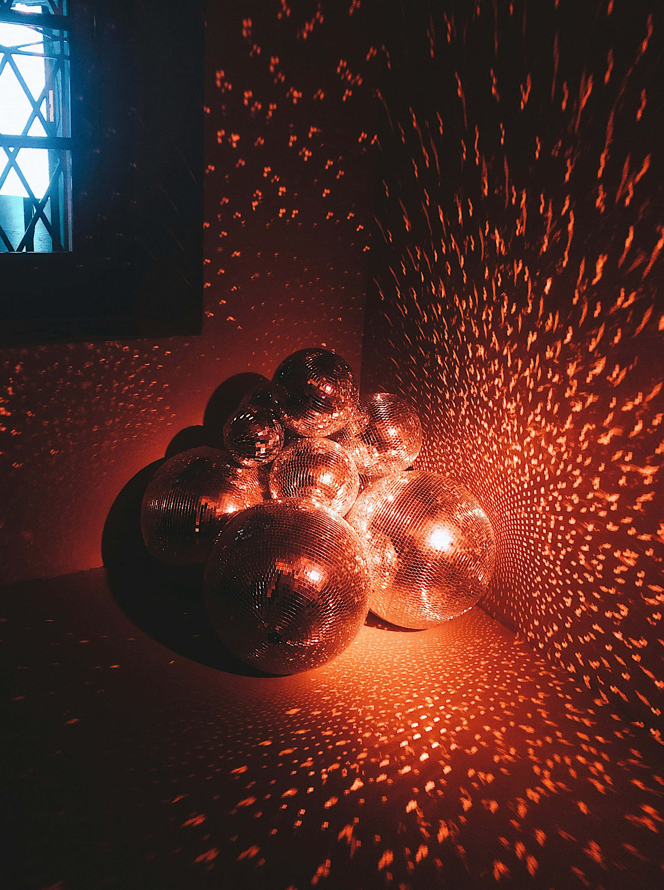 disco ball, fiery orange light, dim room, 2K Phone Wallpaper