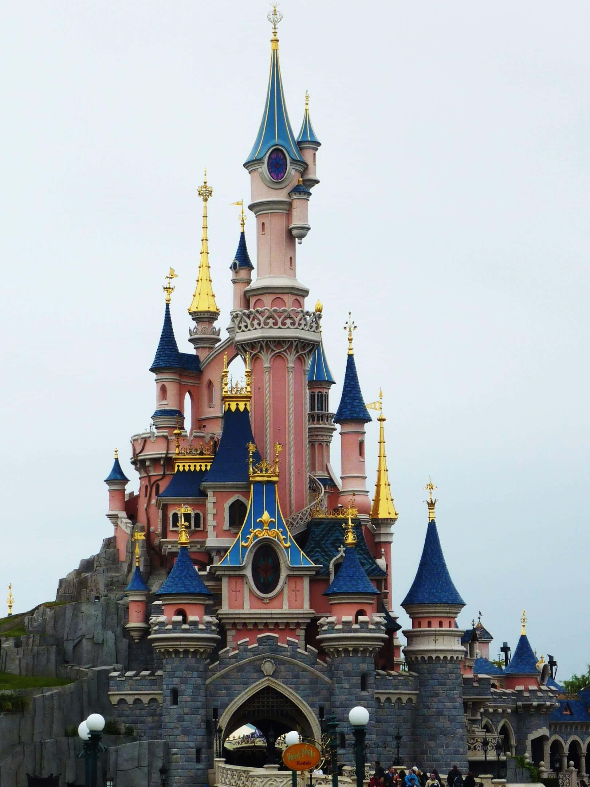Disneyland Paris, pink and blue castle, golden spires, 2K Phone Wallpaper