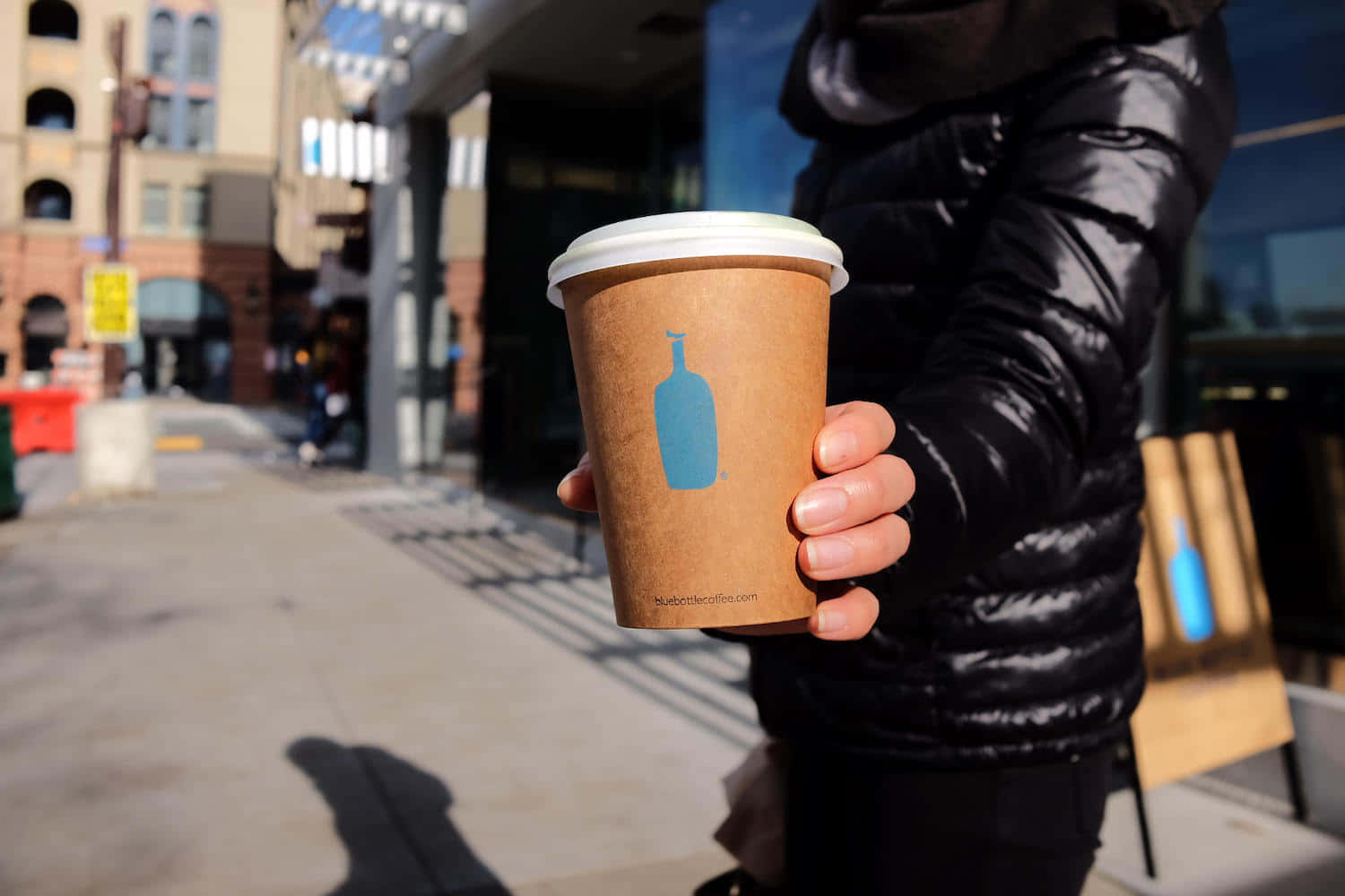Blue Bottle coffee cup, black puffer jacket, sunlit city sidewalk, HD Desktop Wallpaper