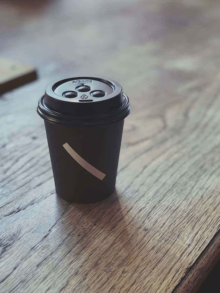 all black disposable cup, gold stripe, weathered wooden table, SD Phone Wallpaper