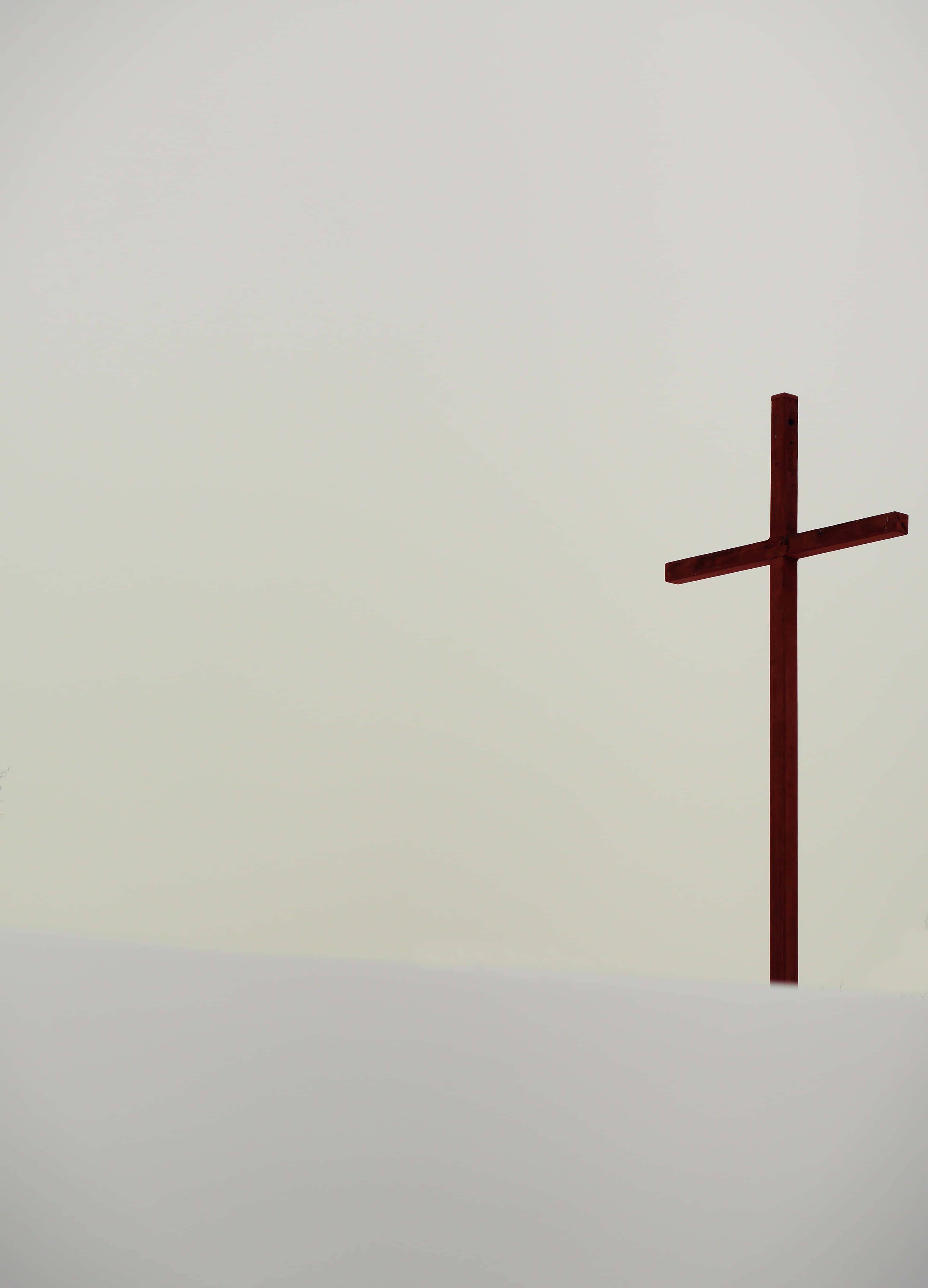 dark wooden cross, pale overcast sky, snowy hillside, 4K Phone Wallpaper