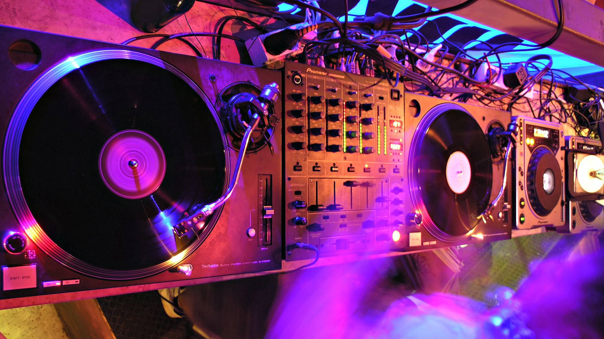 DJ Music Vinyl Mixers, spinning turntables, glowing purple lights, Full HD Desktop Wallpaper