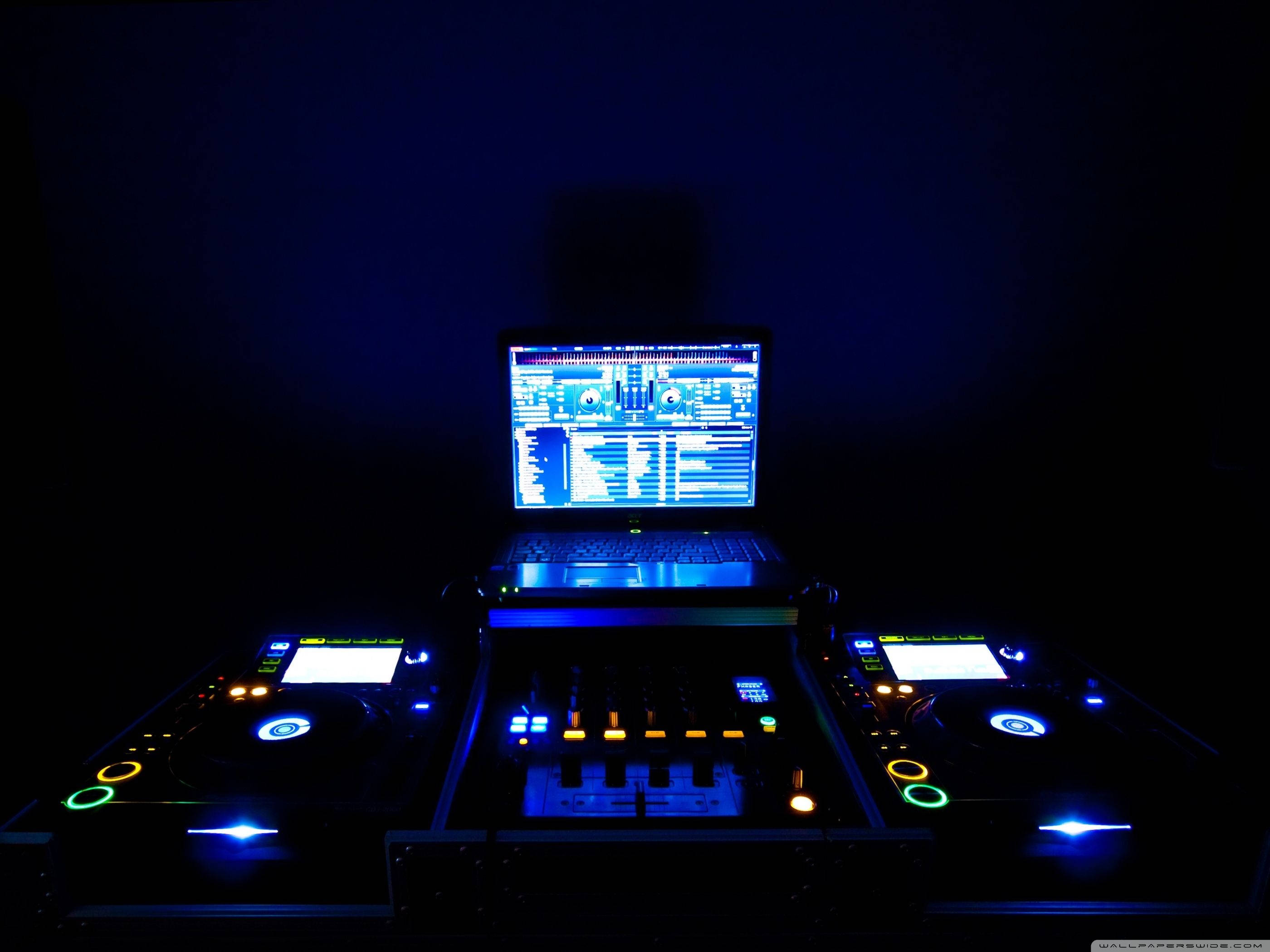 DJ glowing music mixer setup, blue and orange lights, dark room, 2K Desktop Wallpaper