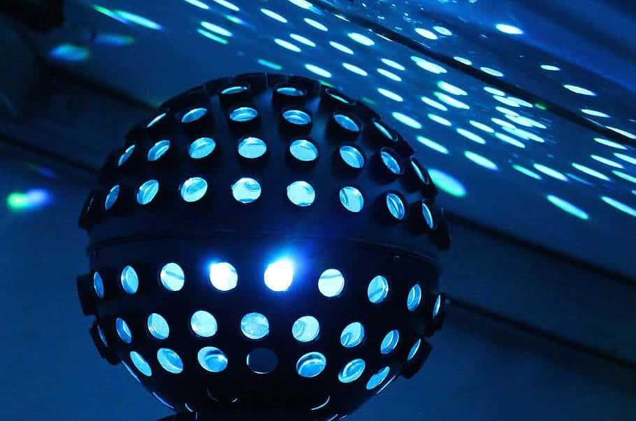 black perforated disco ball, bright blue light, glowing oval reflections, SD Desktop Wallpaper